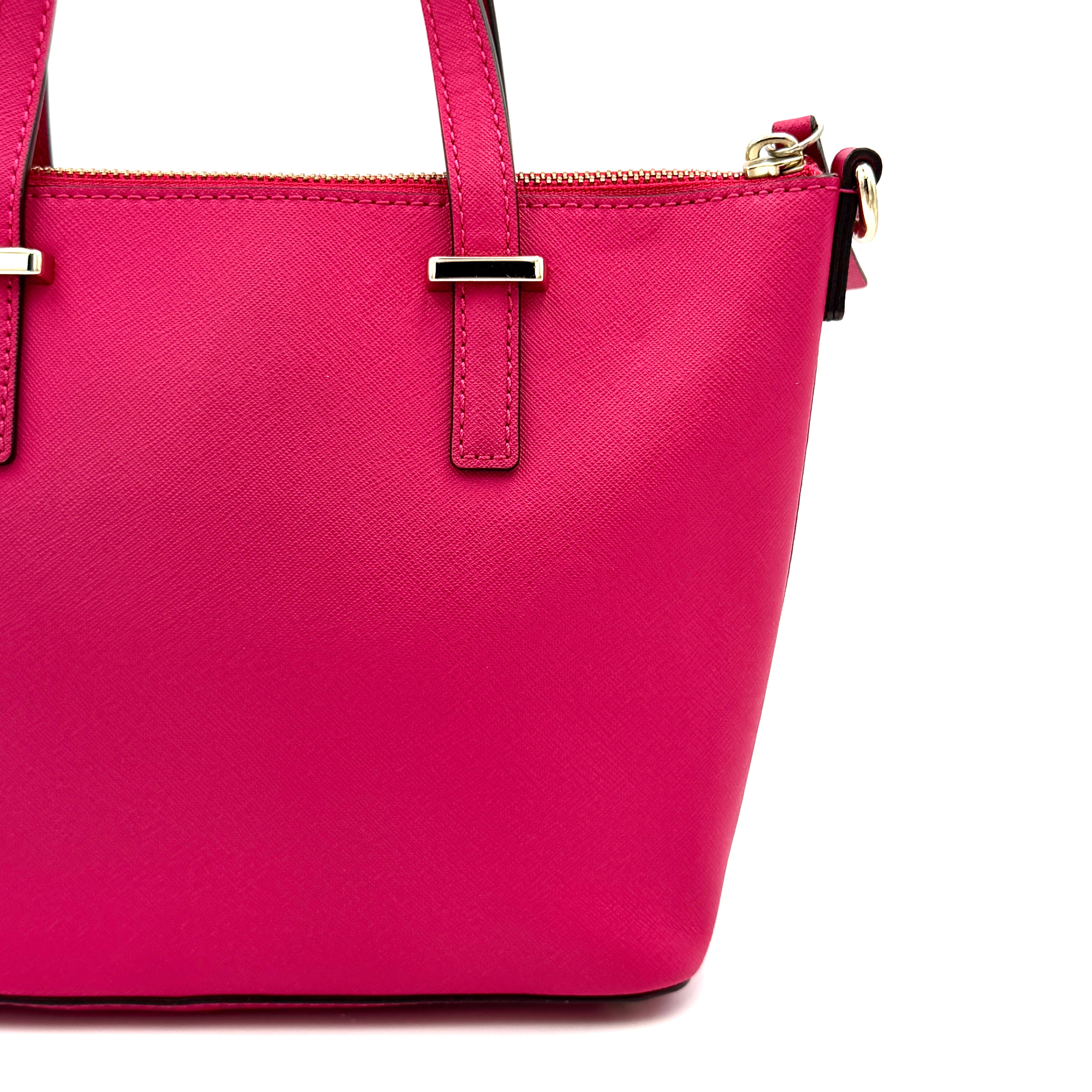 Kate Spade Cedar Street handbag in bold fuchsia pink Saffiano leather, shown with top handles and detachable strap alongside.