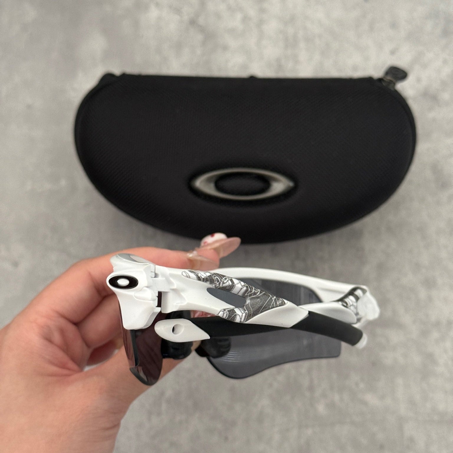 Oakley Prizm Radarlock Path sunglasses with white frame and Prizm lenses, showcasing advanced color and contrast enhancement technology for superior clarity in sports performance.