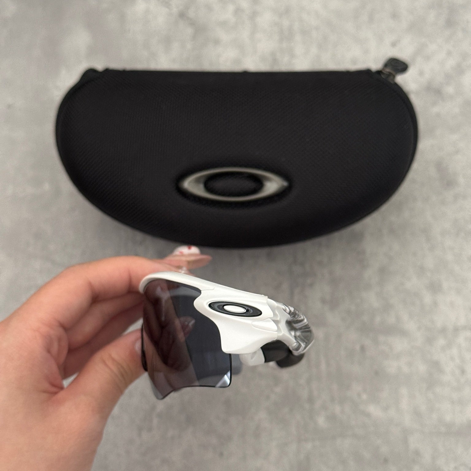 Oakley Prizm Radarlock Path sunglasses with white frame and Prizm lenses, showcasing advanced color and contrast enhancement technology for superior clarity in sports performance.