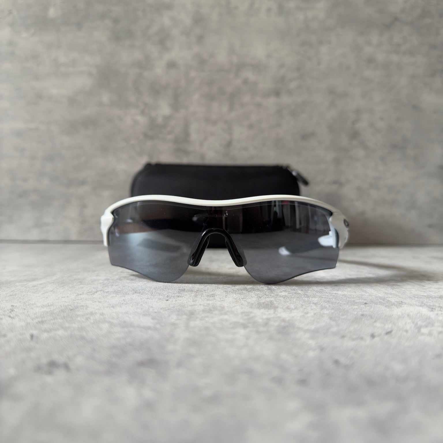 Oakley Prizm Radarlock Path sunglasses with white frame and Prizm lenses, showcasing advanced color and contrast enhancement technology for superior clarity in sports performance.