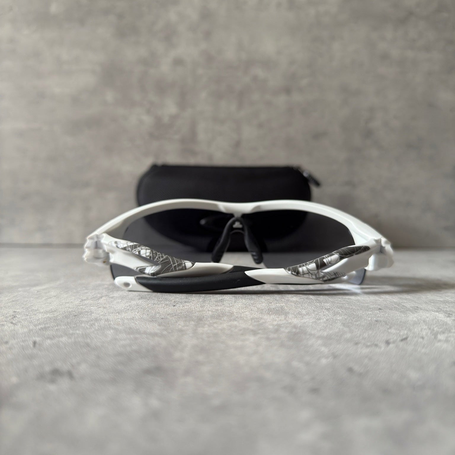 Oakley Prizm Radarlock Path sunglasses with white frame and Prizm lenses, showcasing advanced color and contrast enhancement technology for superior clarity in sports performance.