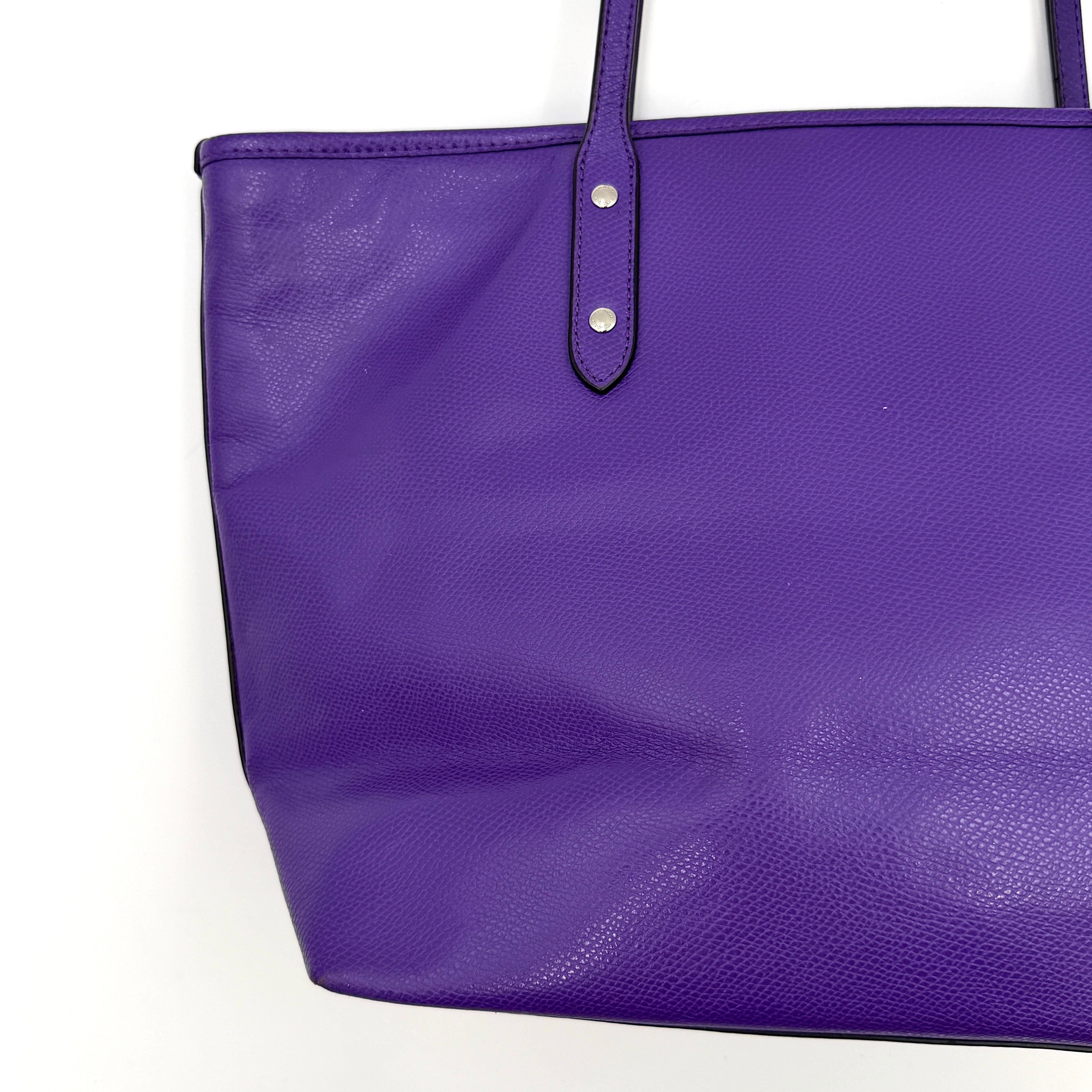 Coach City Zip Tote Bag in vibrant purple grained leather with dual shoulder straps and silver-tone hardware.