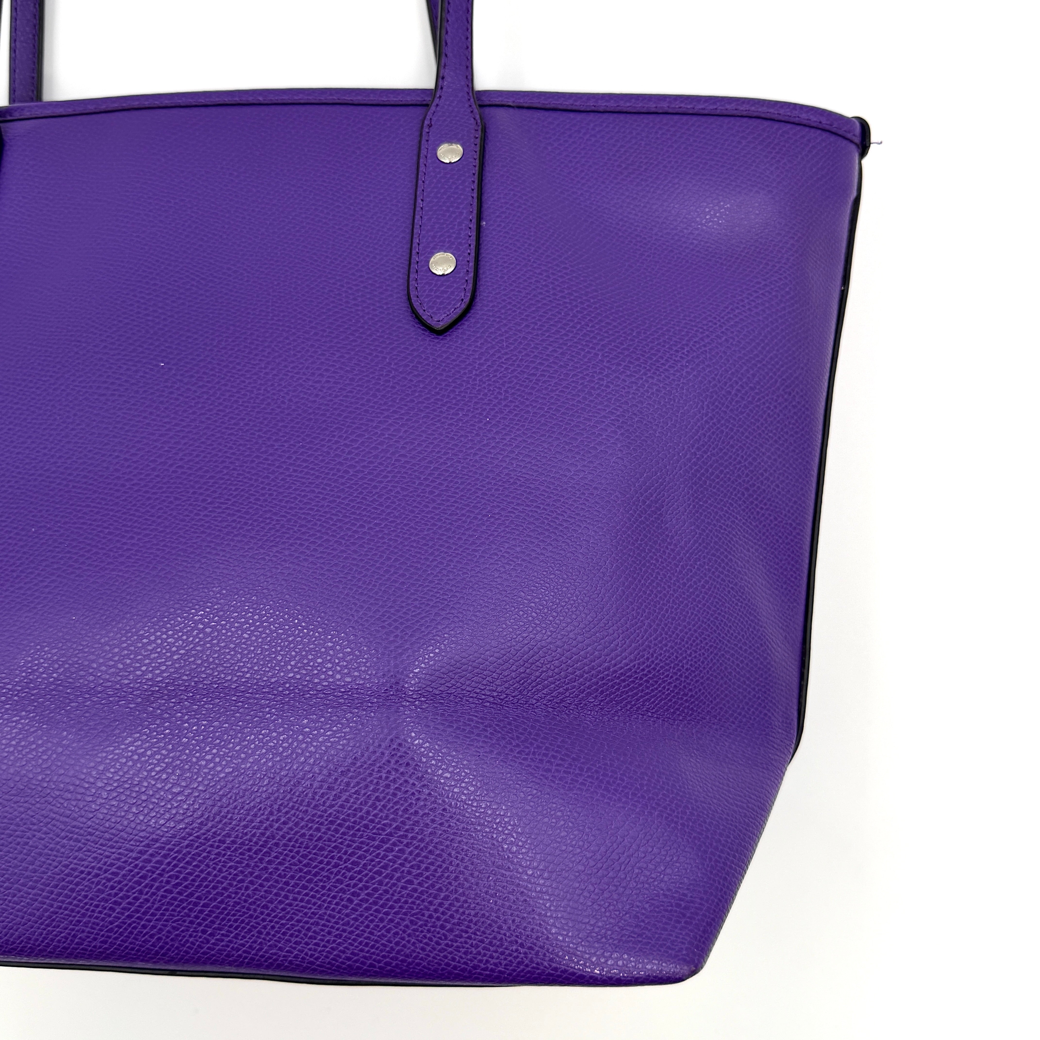 Coach City Zip Tote Bag in vibrant purple grained leather with dual shoulder straps and silver-tone hardware.