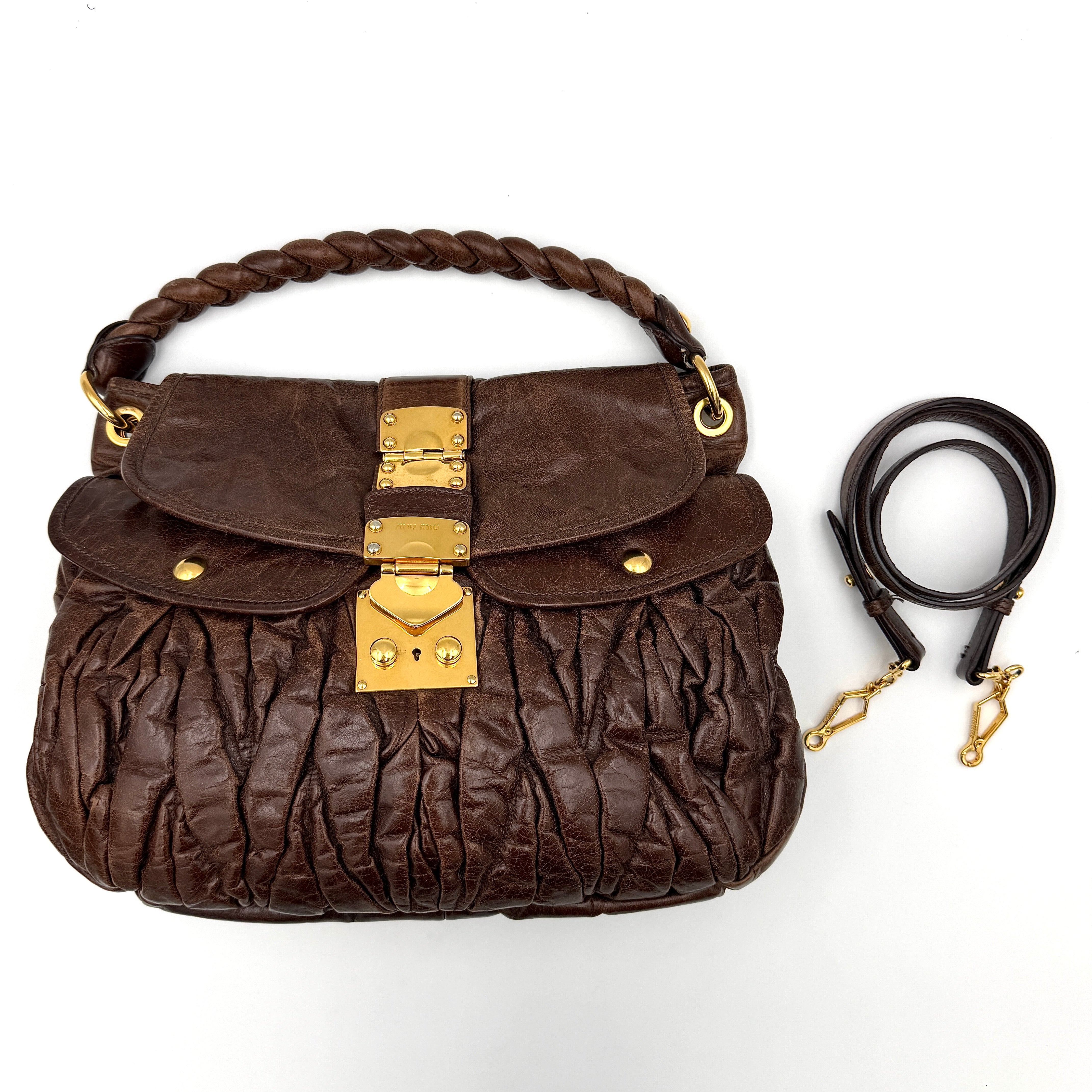 Miu Miu Coffer Hobo bag in deep brown matelassé leather with braided handle, gold hardware, and detachable strap.