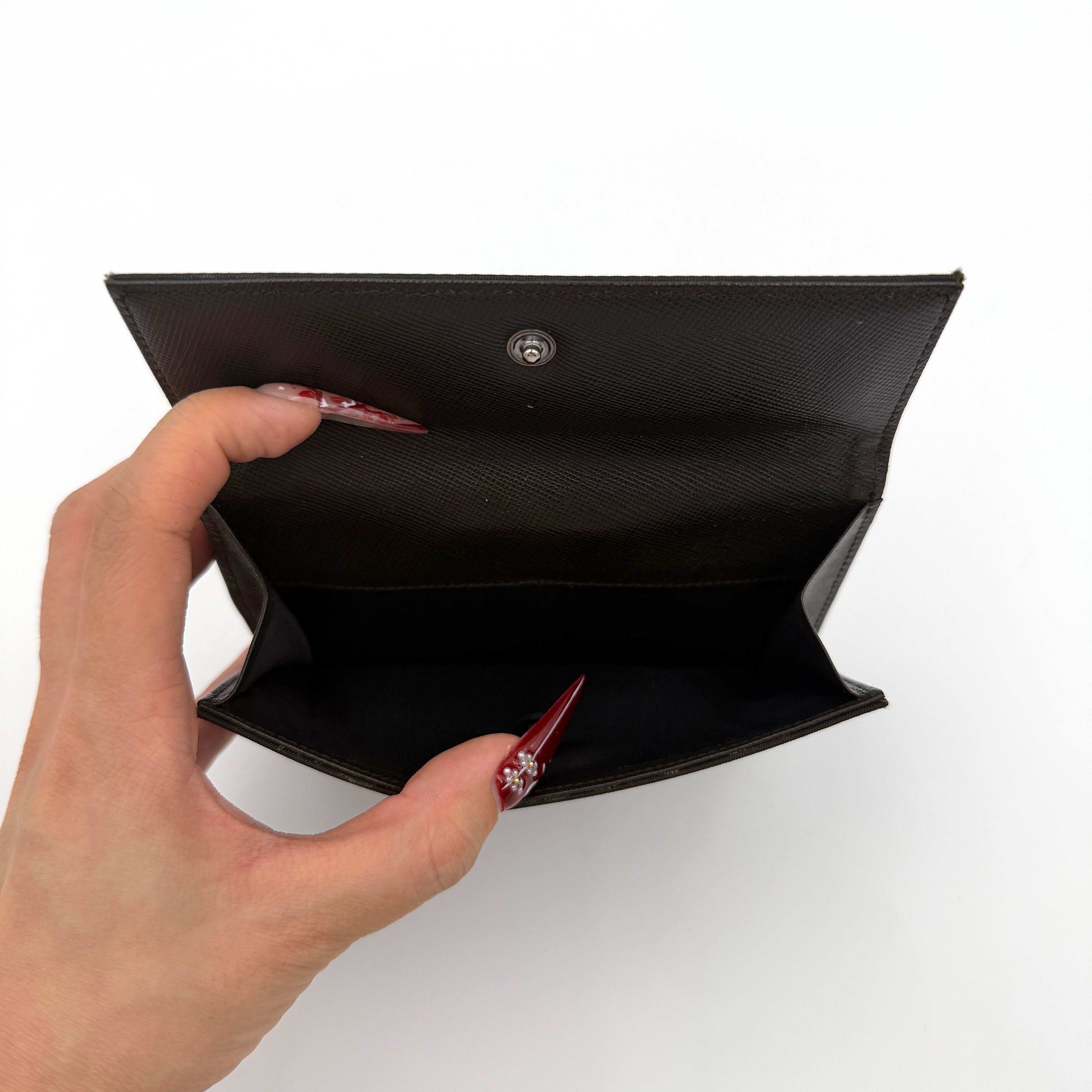 Prada Tessuto Nylon Bifold Wallet in black featuring the iconic enamel triangle logo on the front flap.