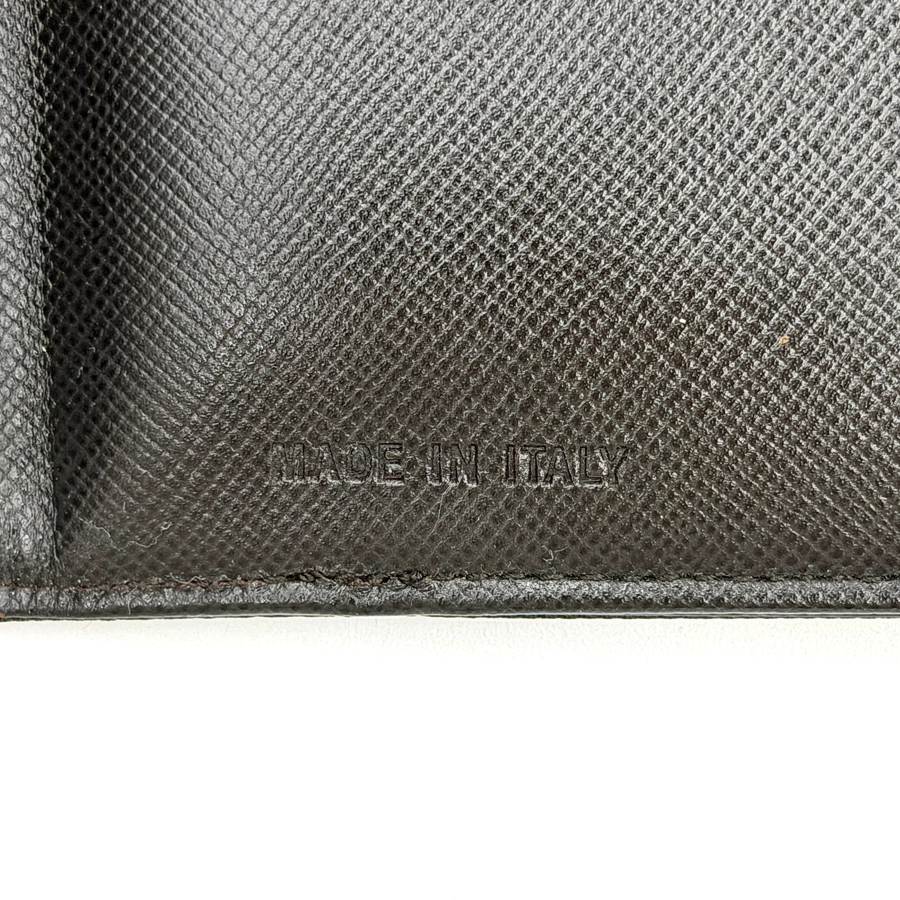 Prada Tessuto Nylon Bifold Wallet in black featuring the iconic enamel triangle logo on the front flap.