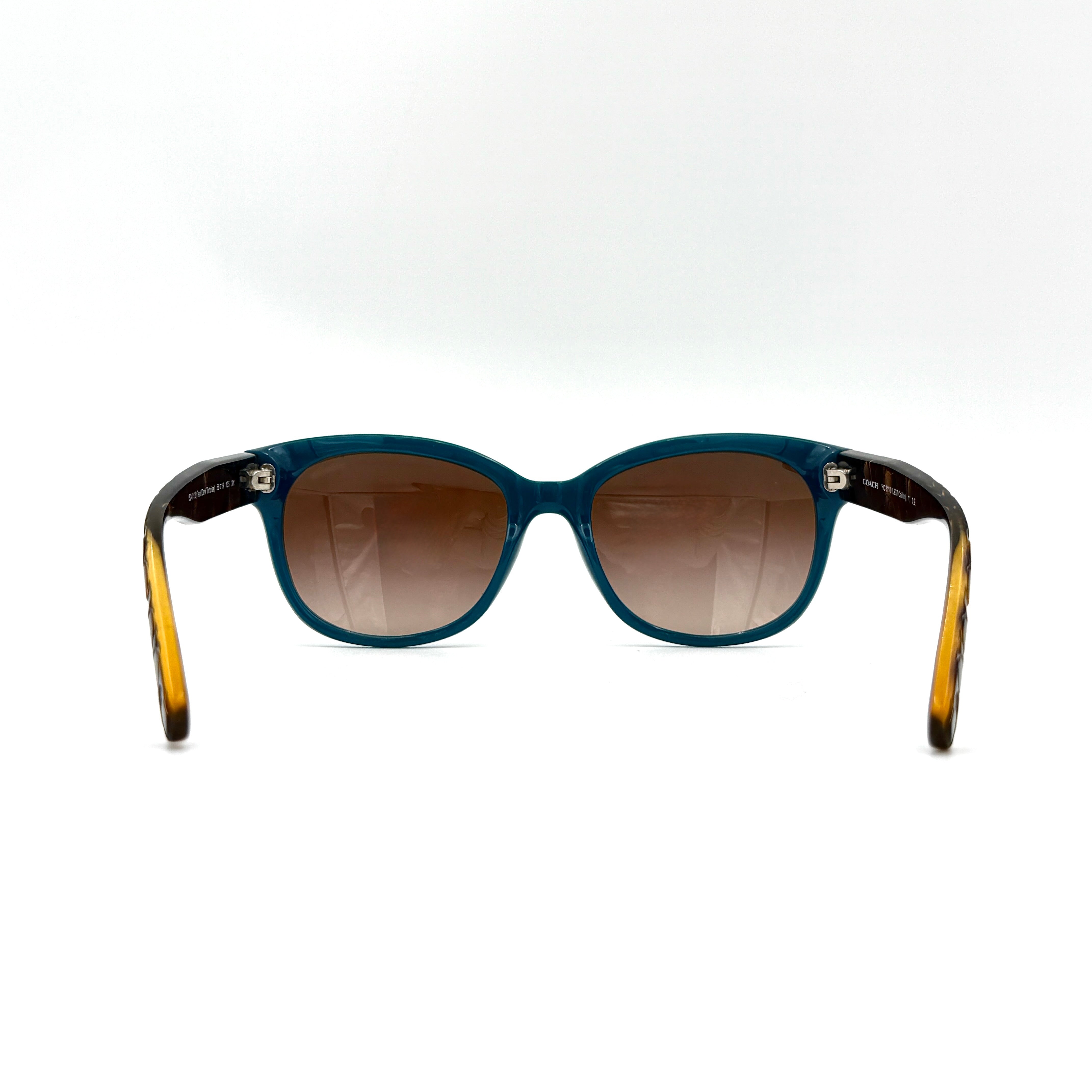 Coach HC8110 sunglasses in teal and dark tortoiseshell acetate with gradient brown lenses, shown at a three-quarter angle.