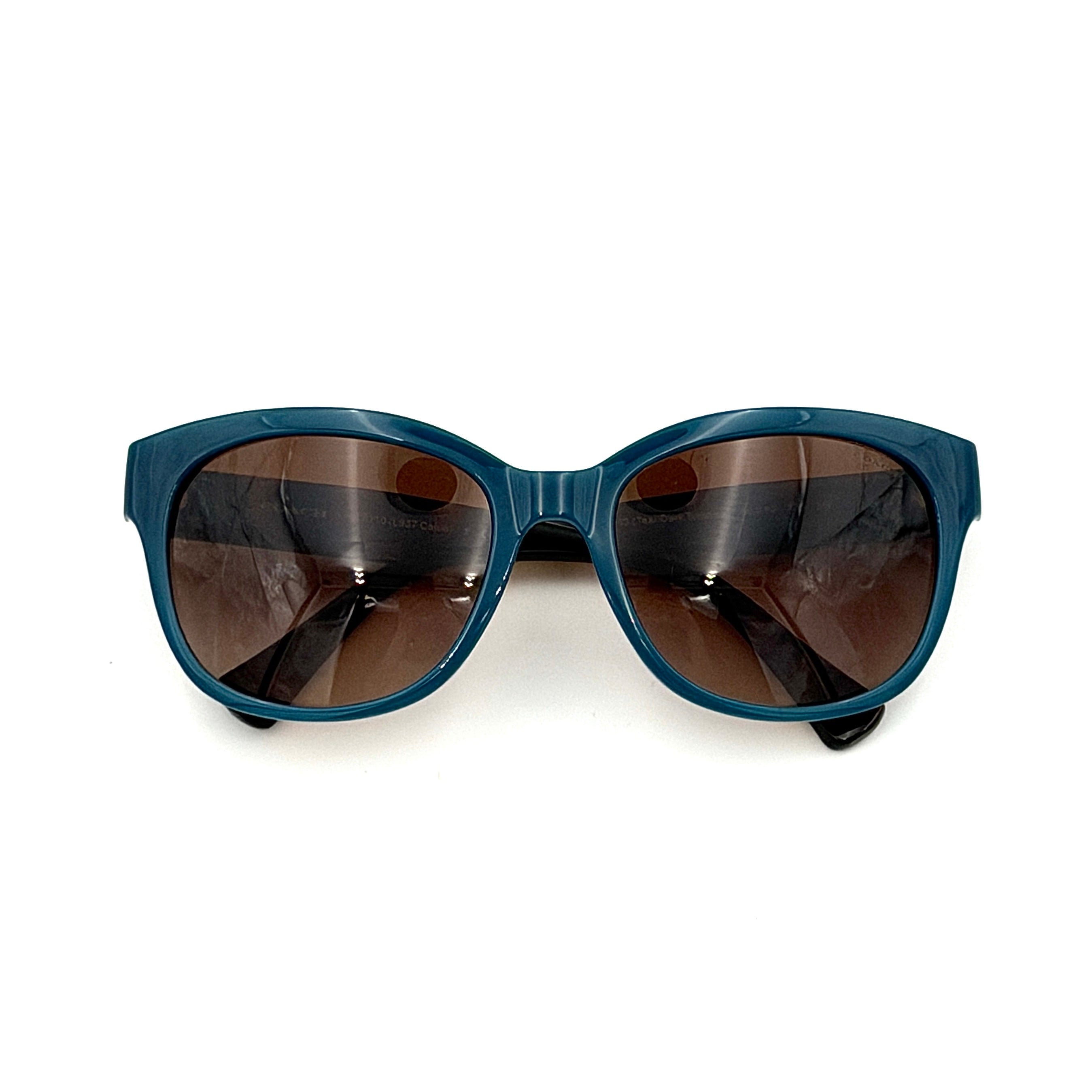 Coach HC8110 sunglasses in teal and dark tortoiseshell acetate with gradient brown lenses, shown at a three-quarter angle.