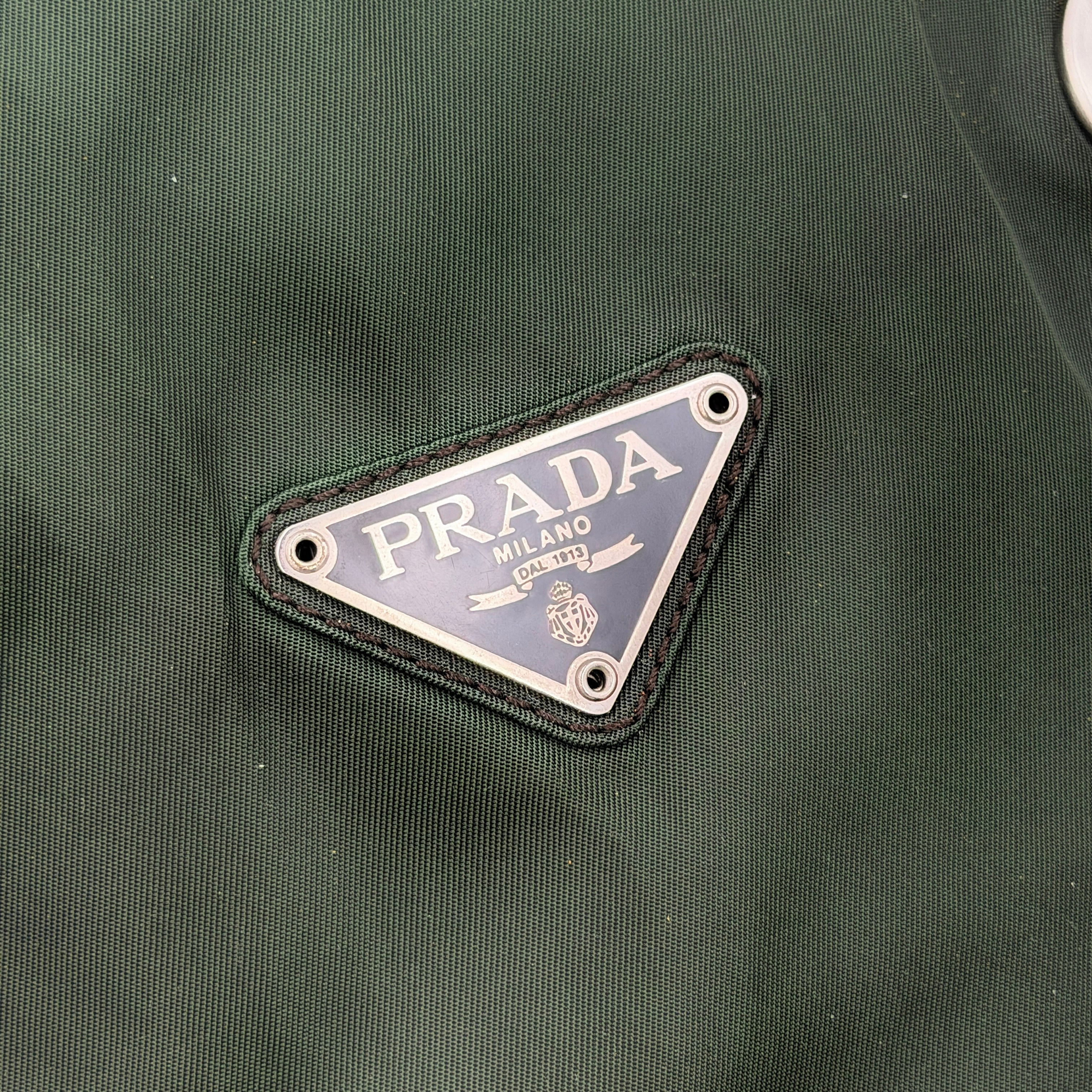 A Prada Tessuto Nylon Chain Shoulder Bag in deep green with silver-tone chain straps, featuring the iconic triangular logo on the front.