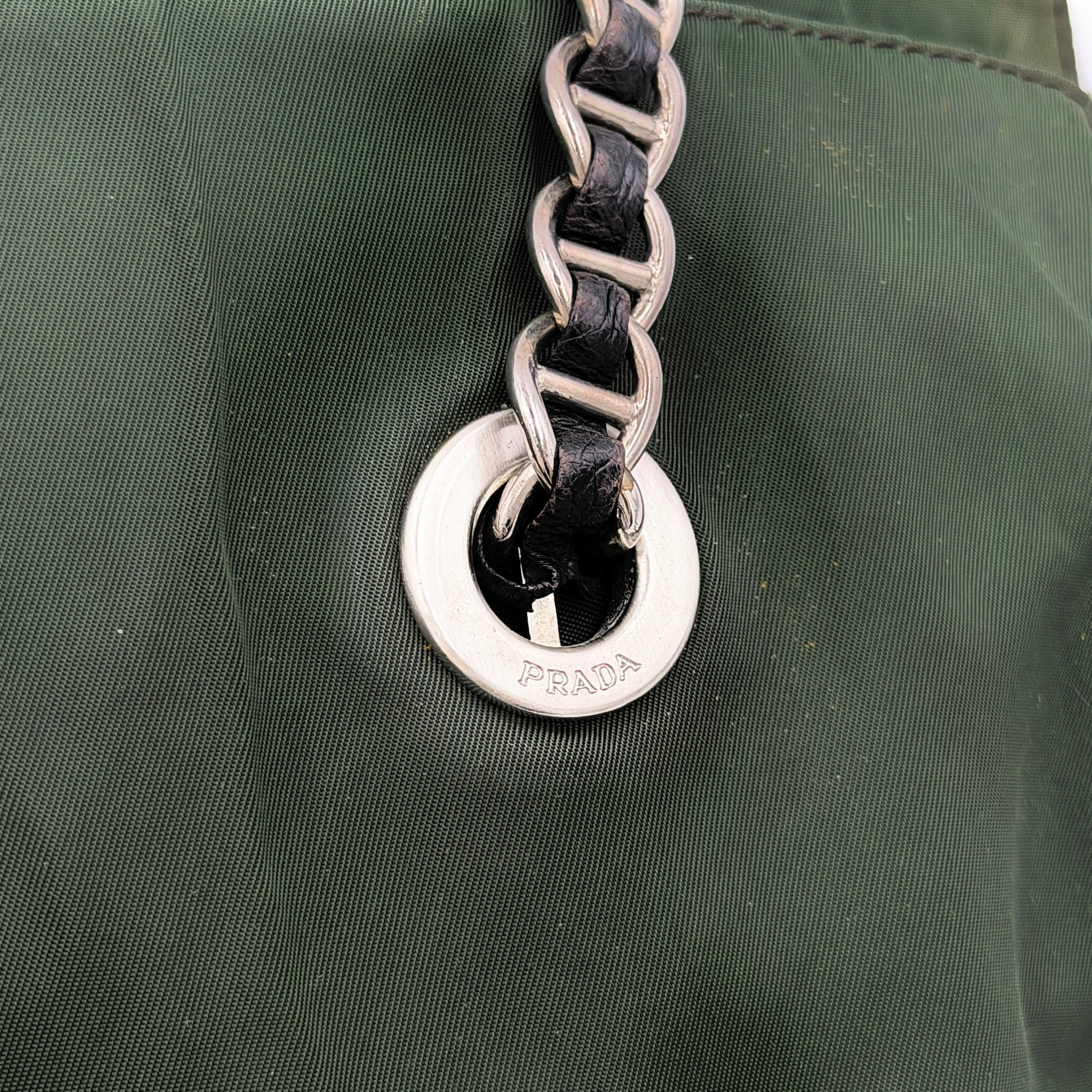 A Prada Tessuto Nylon Chain Shoulder Bag in deep green with silver-tone chain straps, featuring the iconic triangular logo on the front.