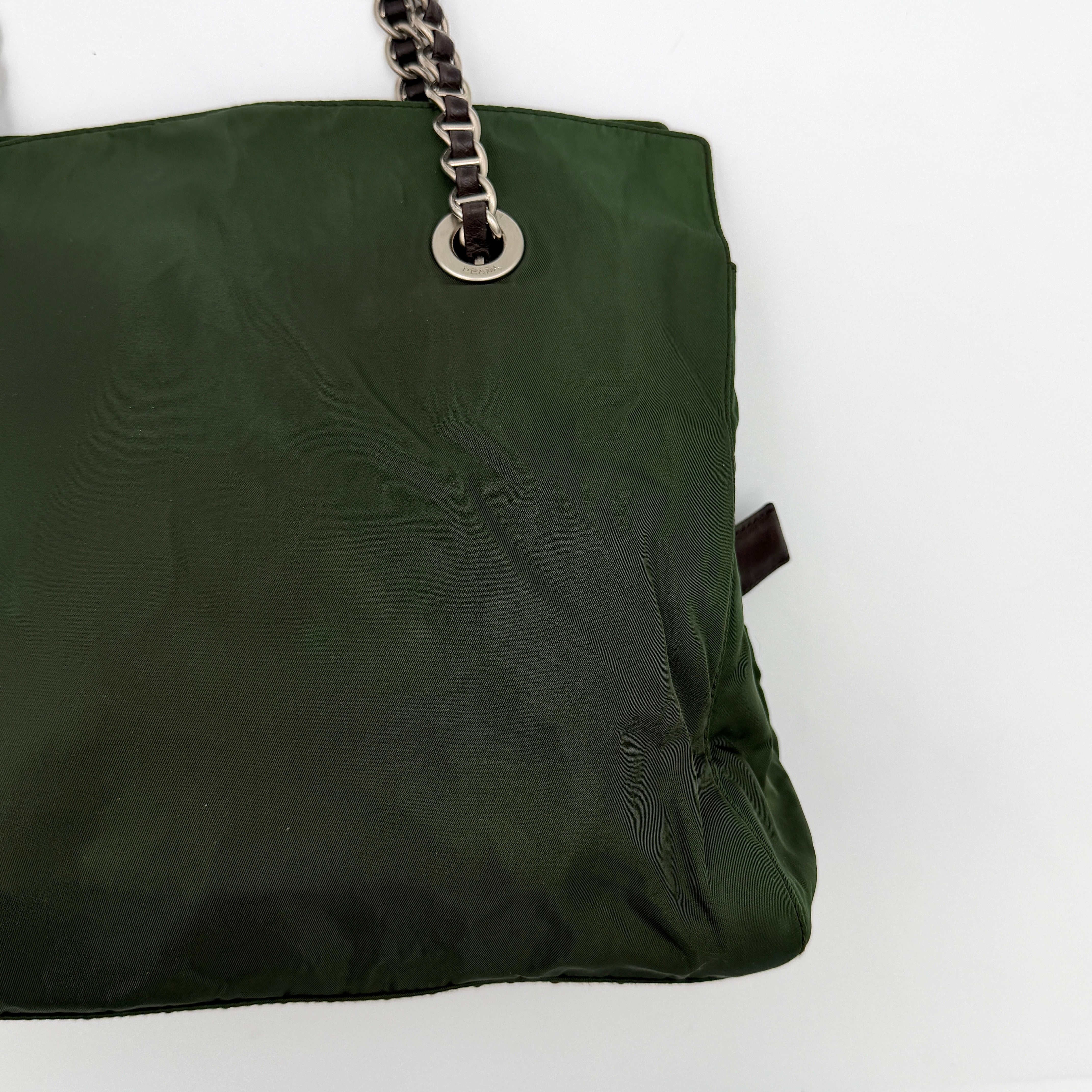 A Prada Tessuto Nylon Chain Shoulder Bag in deep green with silver-tone chain straps, featuring the iconic triangular logo on the front.