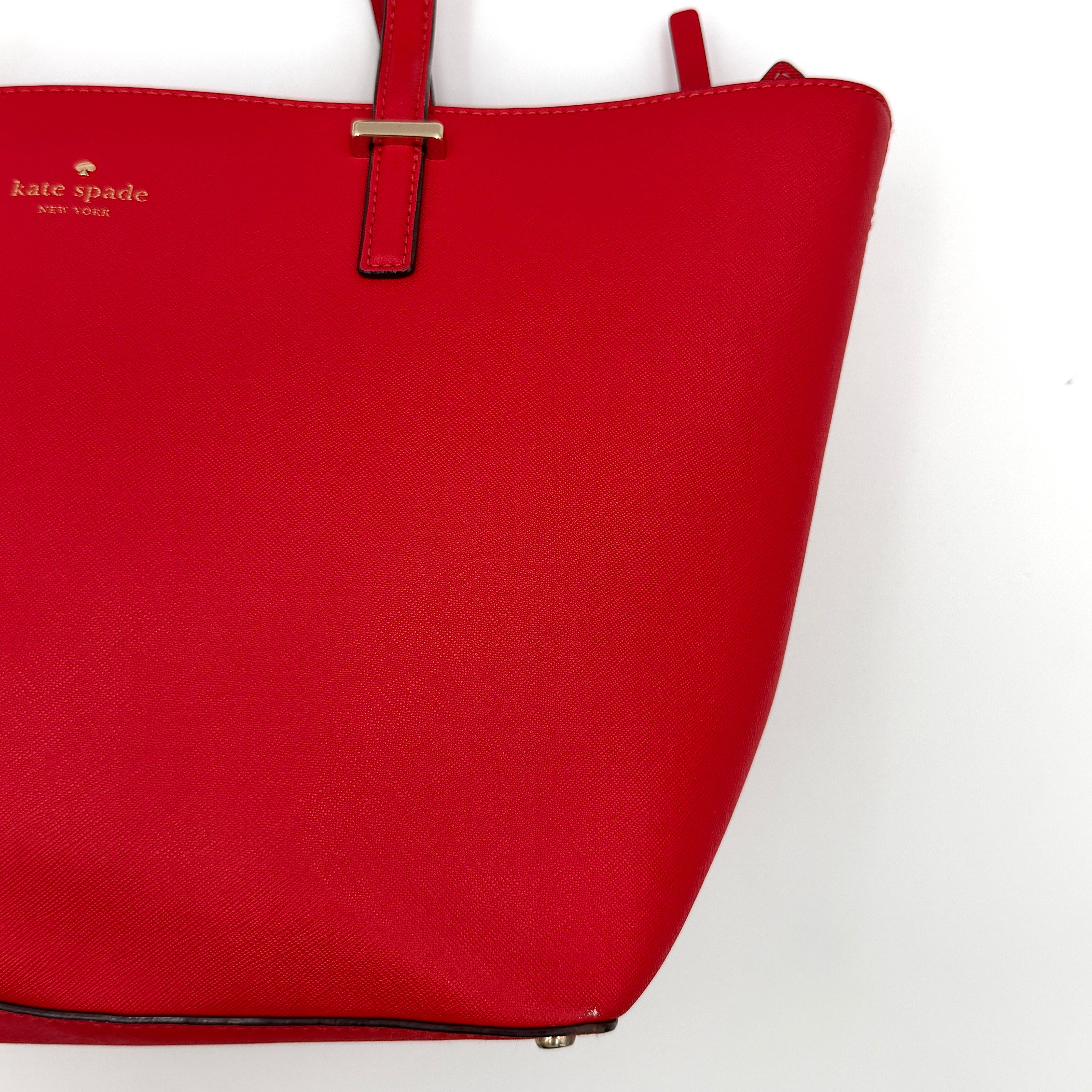 A vivid red Kate Spade Cedar Street Harmony Tote Bag with structured handles and gold-tone logo, shown against a white background.