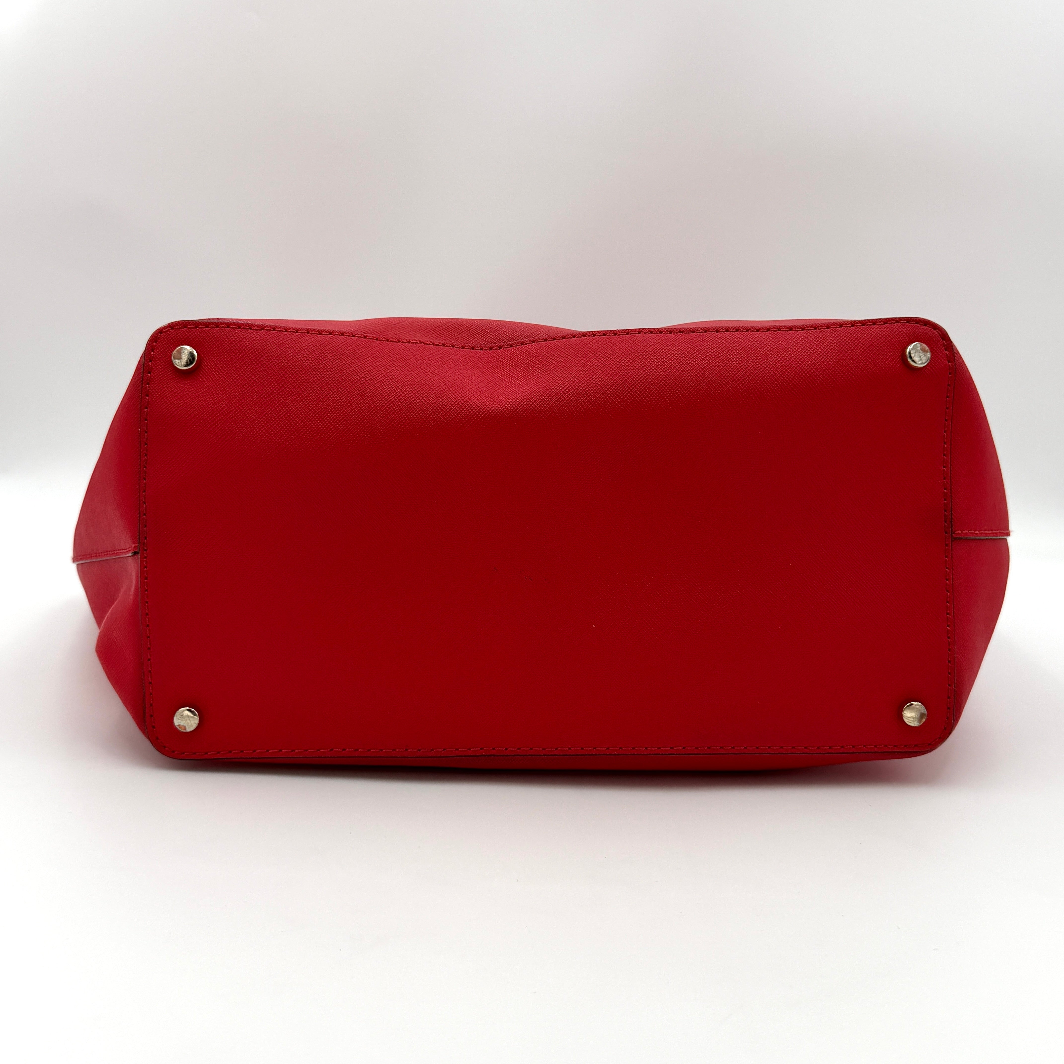 A vivid red Kate Spade Cedar Street Harmony Tote Bag with structured handles and gold-tone logo, shown against a white background.