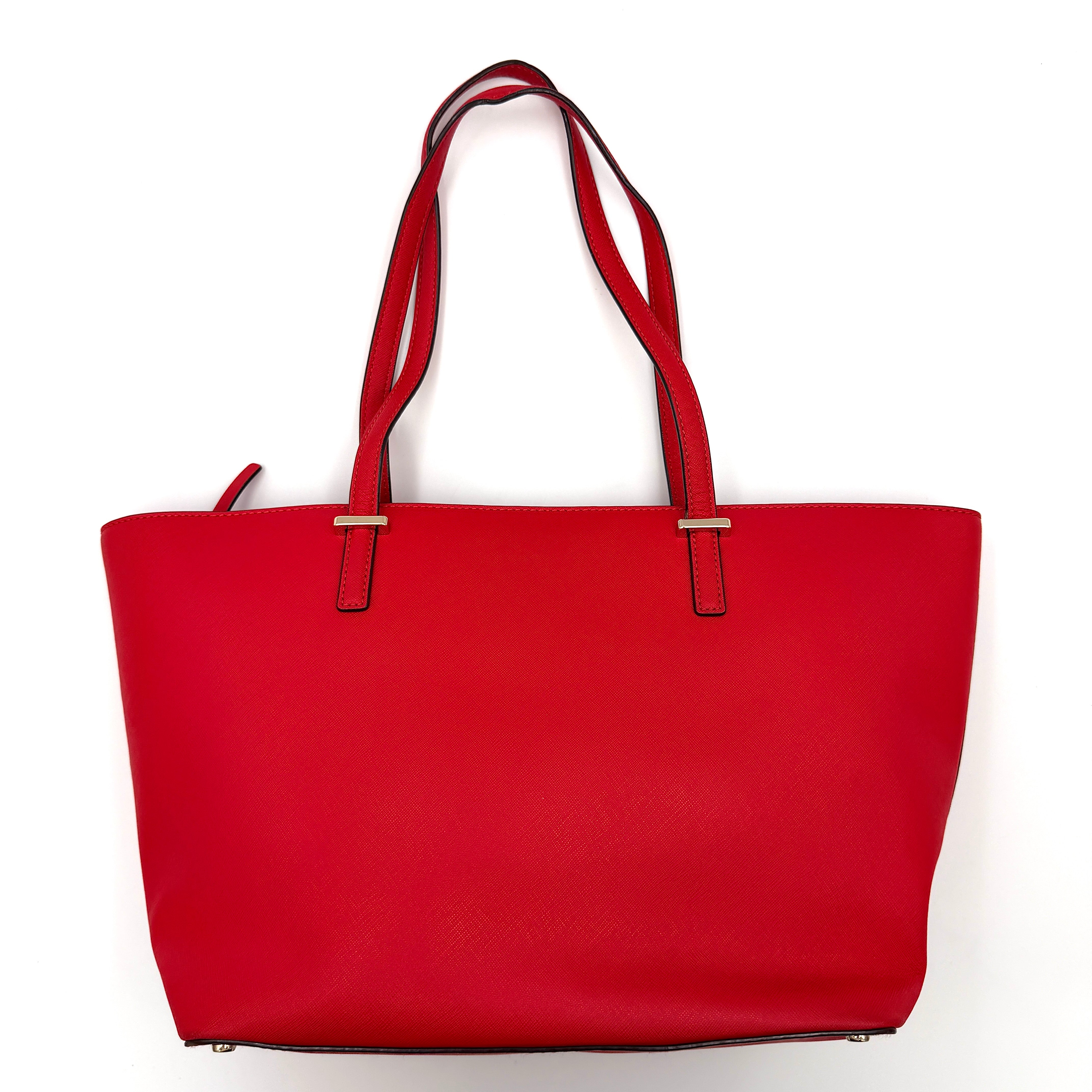 A vivid red Kate Spade Cedar Street Harmony Tote Bag with structured handles and gold-tone logo, shown against a white background.