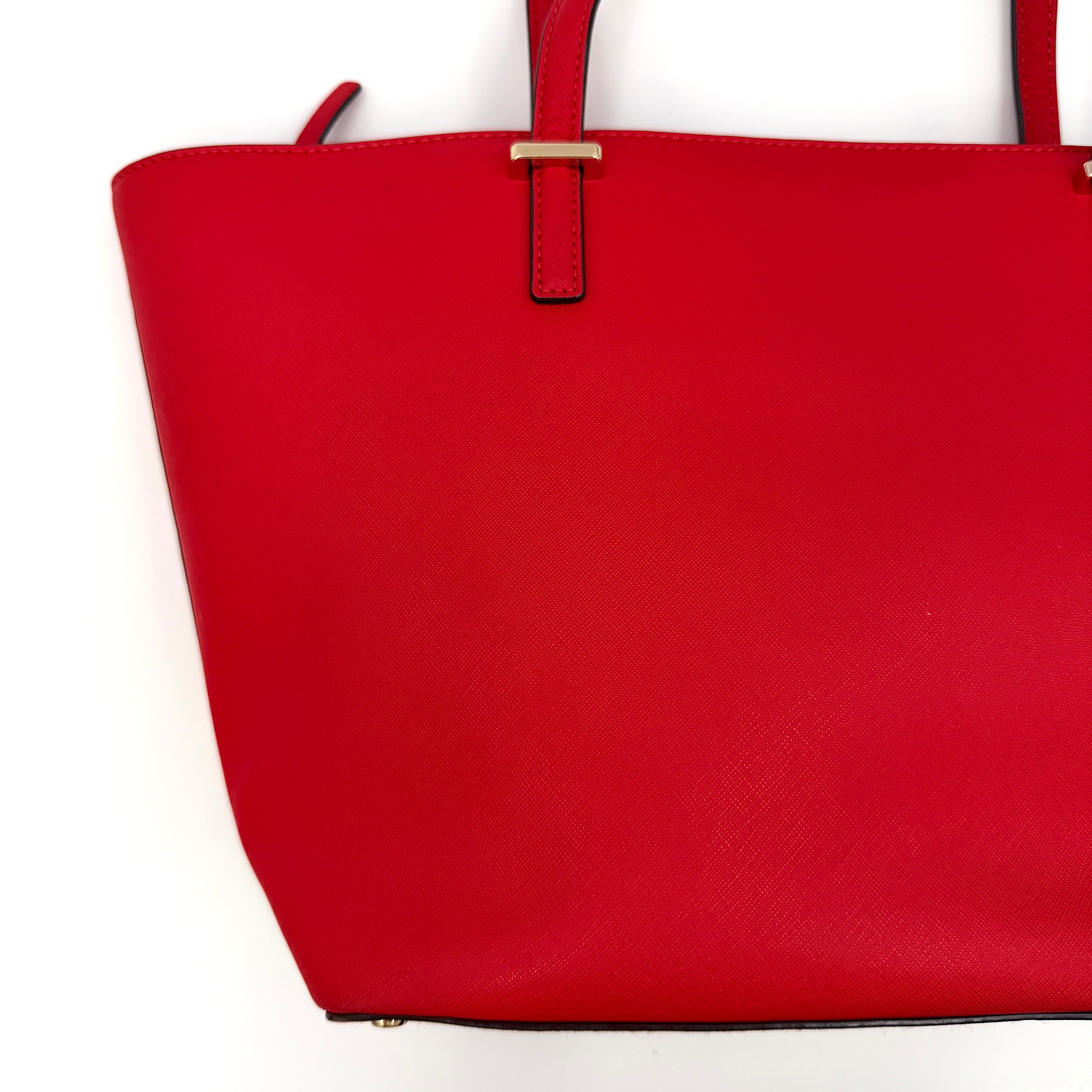 A vivid red Kate Spade Cedar Street Harmony Tote Bag with structured handles and gold-tone logo, shown against a white background.