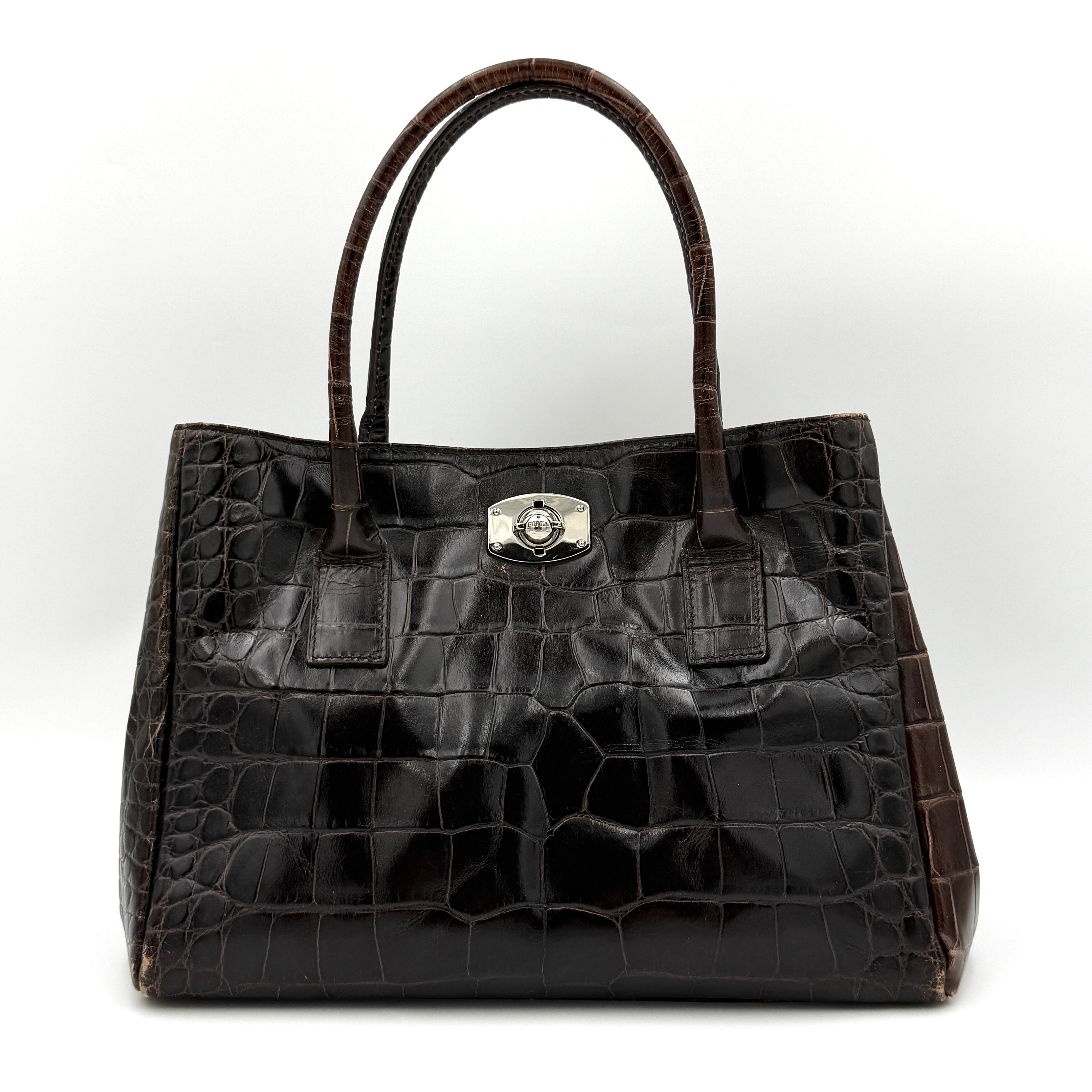 Furla croc-embossed dark brown leather handbag with structured silhouette, dual top handles, and silver turn-lock closure.