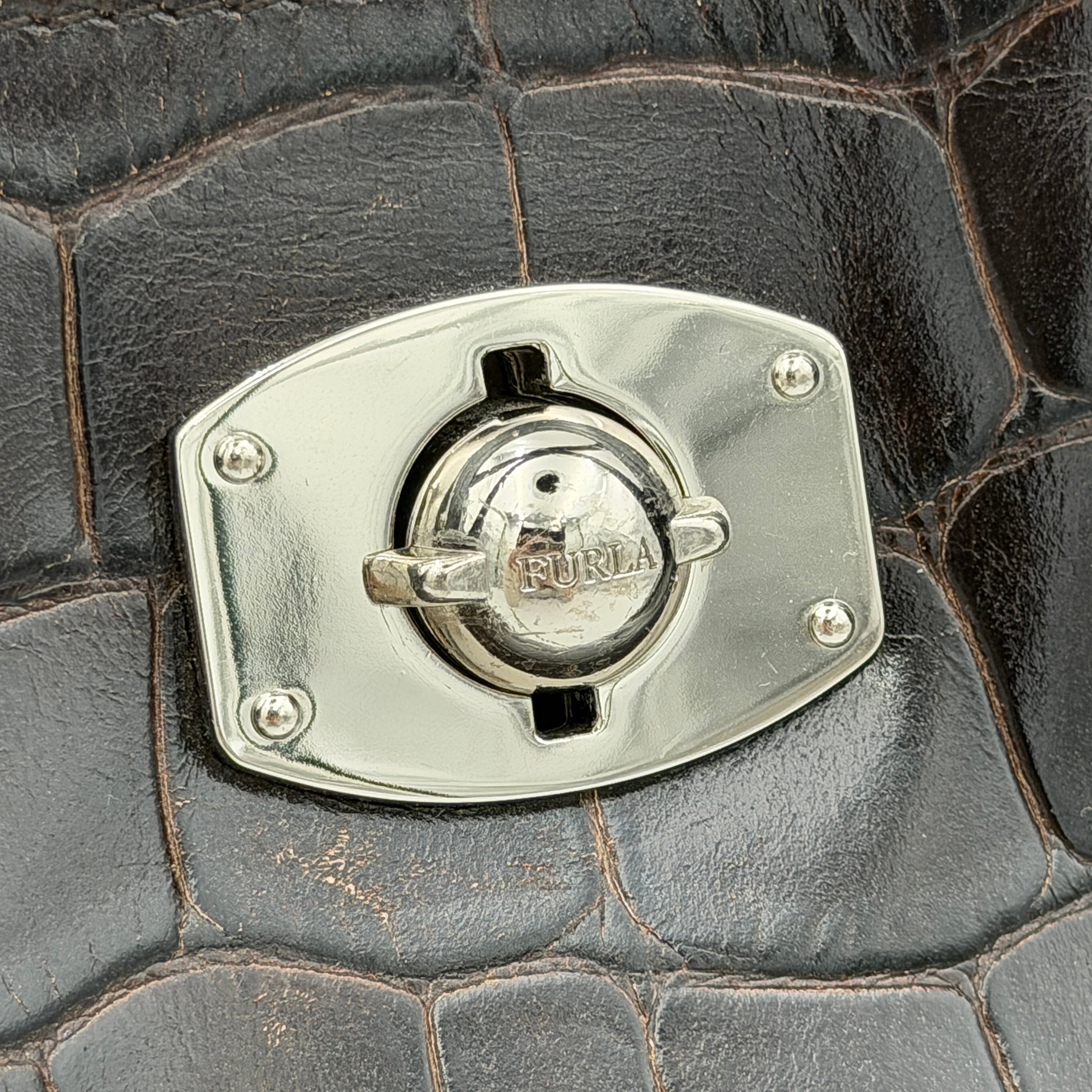 Furla croc-embossed dark brown leather handbag with structured silhouette, dual top handles, and silver turn-lock closure.