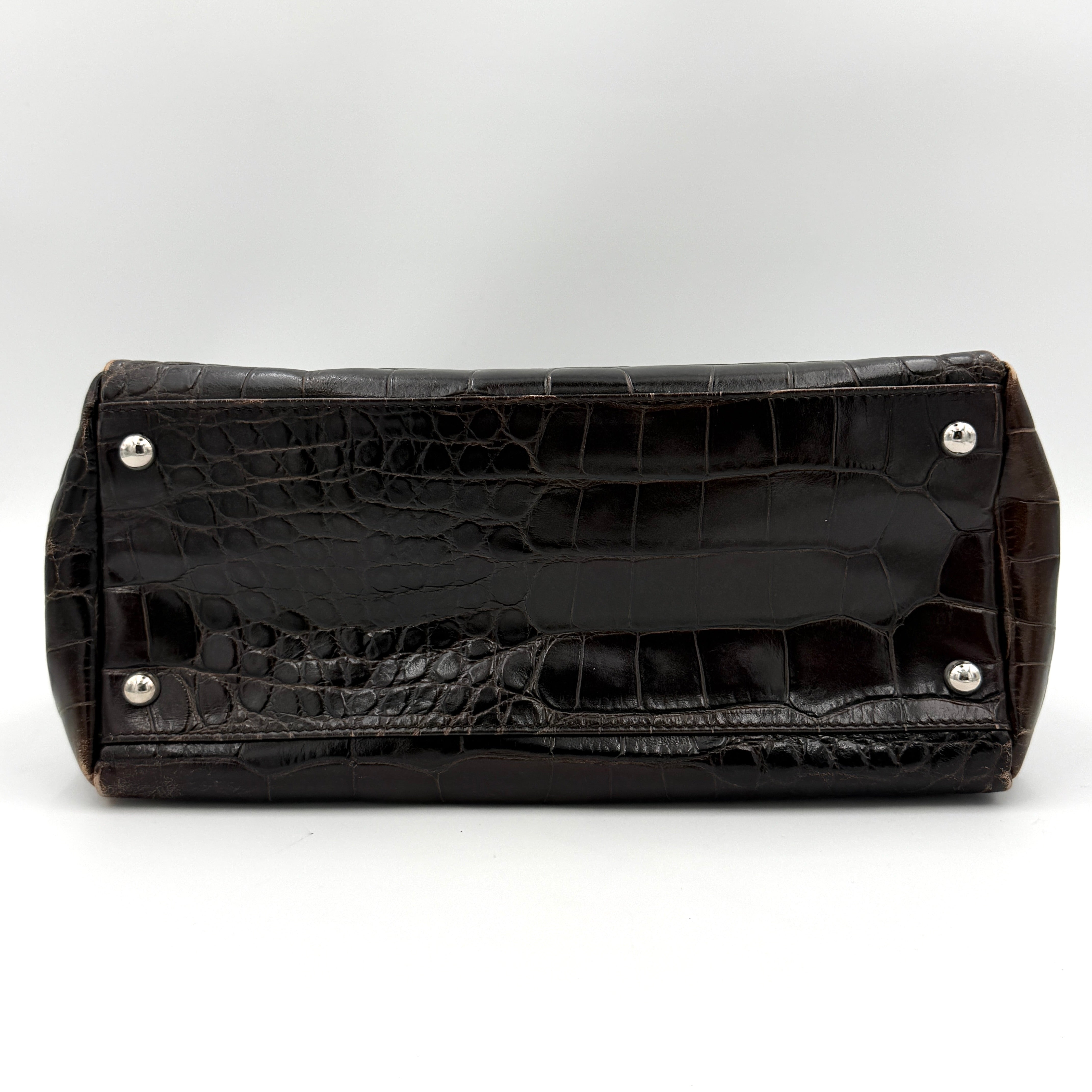 Furla croc-embossed dark brown leather handbag with structured silhouette, dual top handles, and silver turn-lock closure.