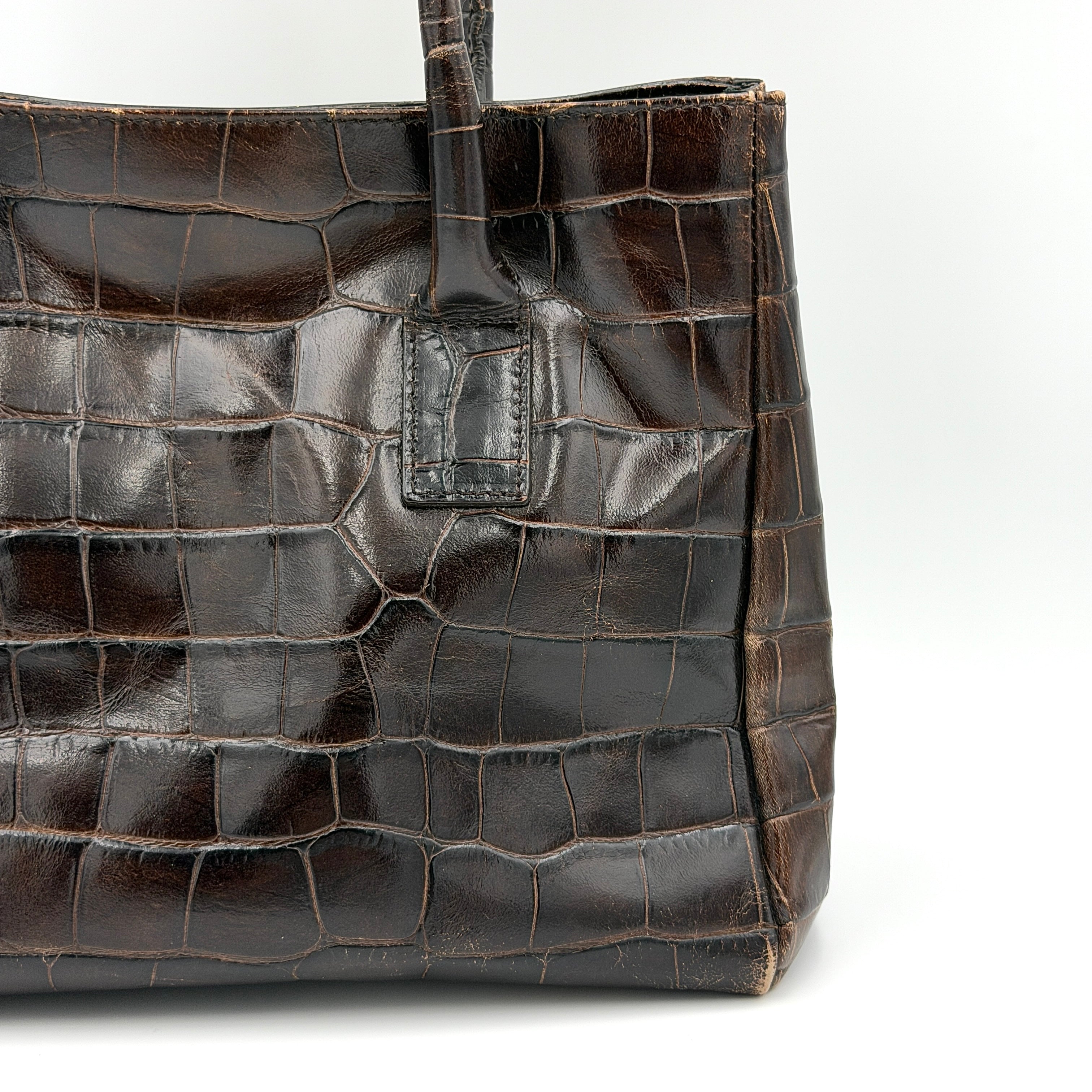 Furla croc-embossed dark brown leather handbag with structured silhouette, dual top handles, and silver turn-lock closure.