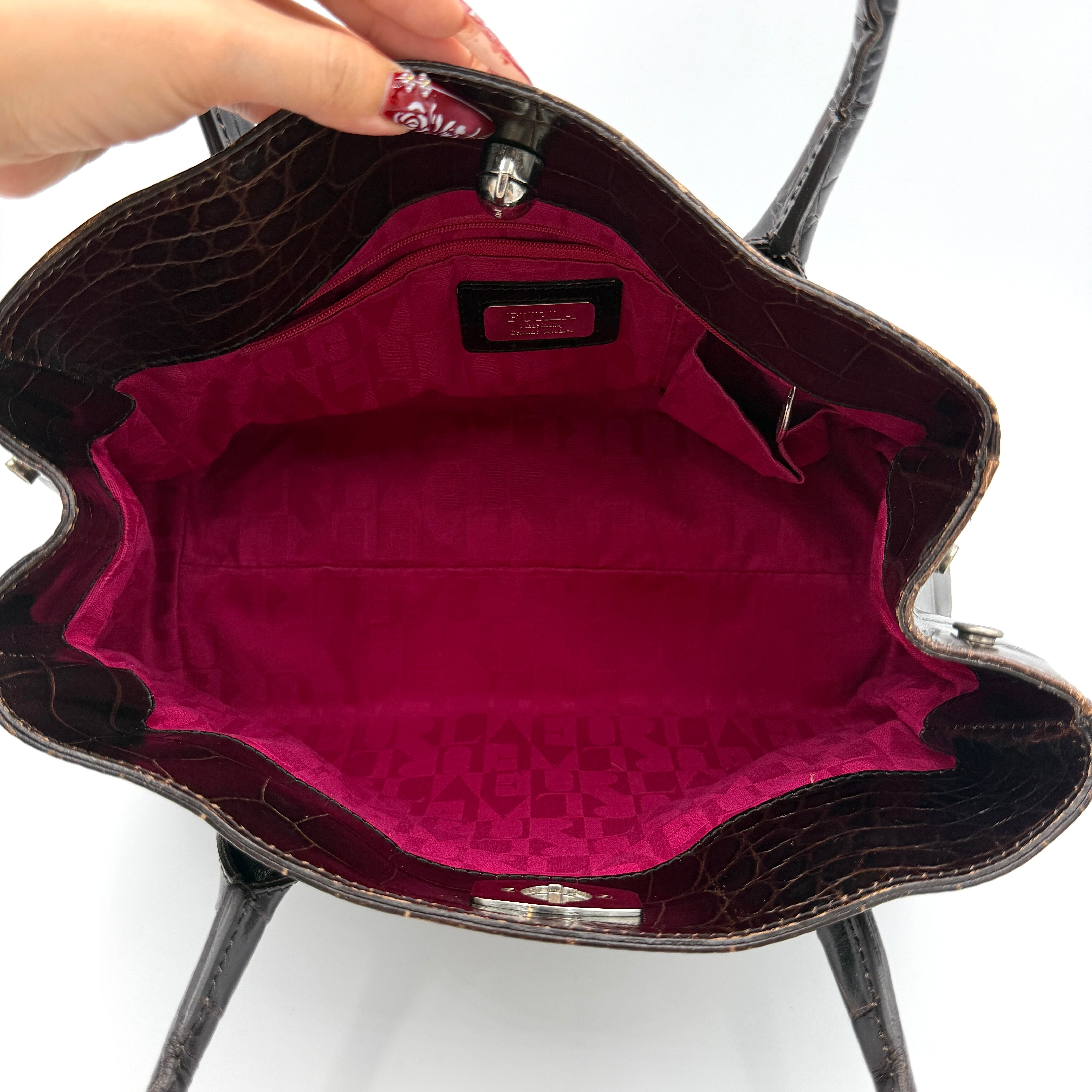 Furla croc-embossed dark brown leather handbag with structured silhouette, dual top handles, and silver turn-lock closure.