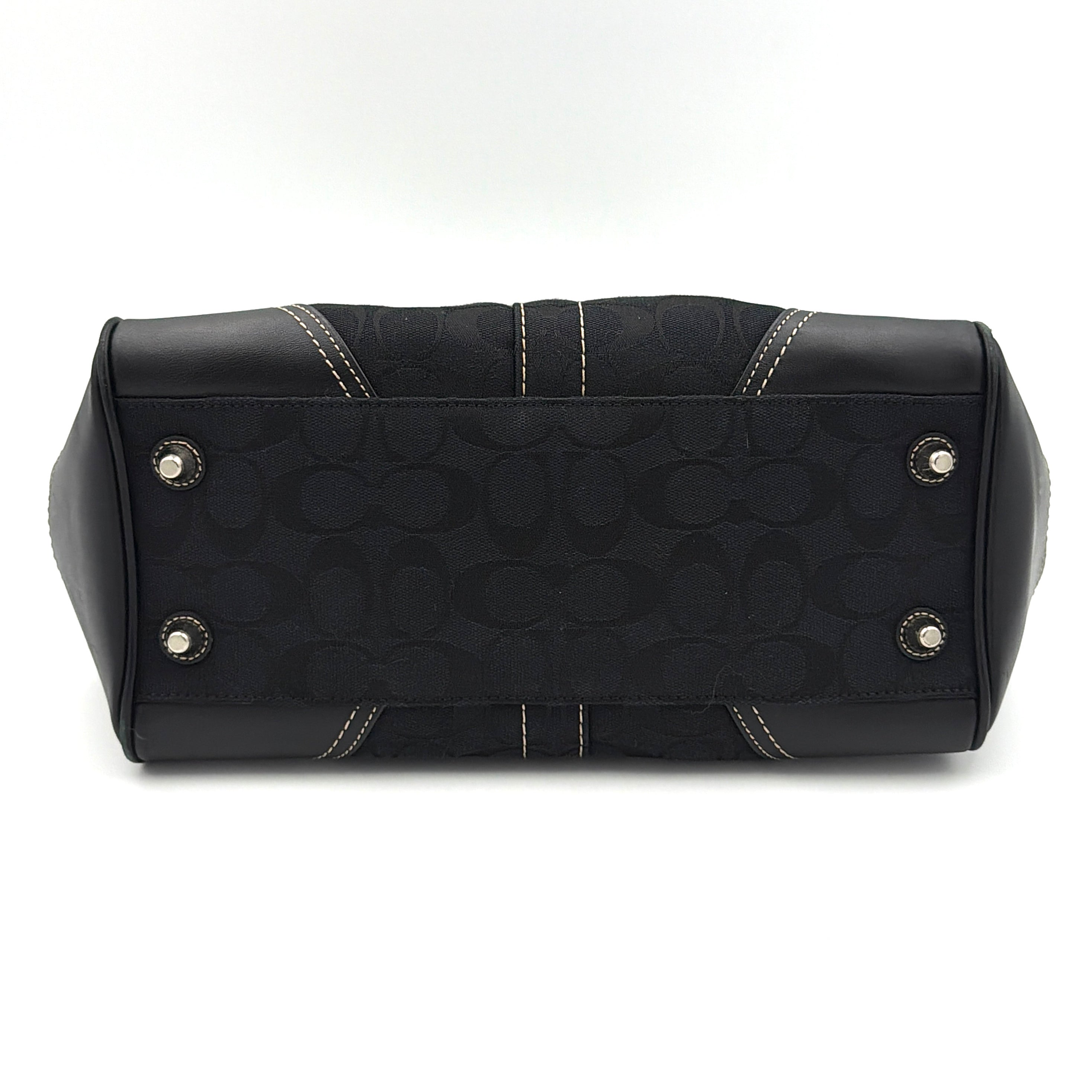 Coach Signature Hampton Carryall in black with monogram jacquard, belted leather trim, and silver-tone horsebit hardware.