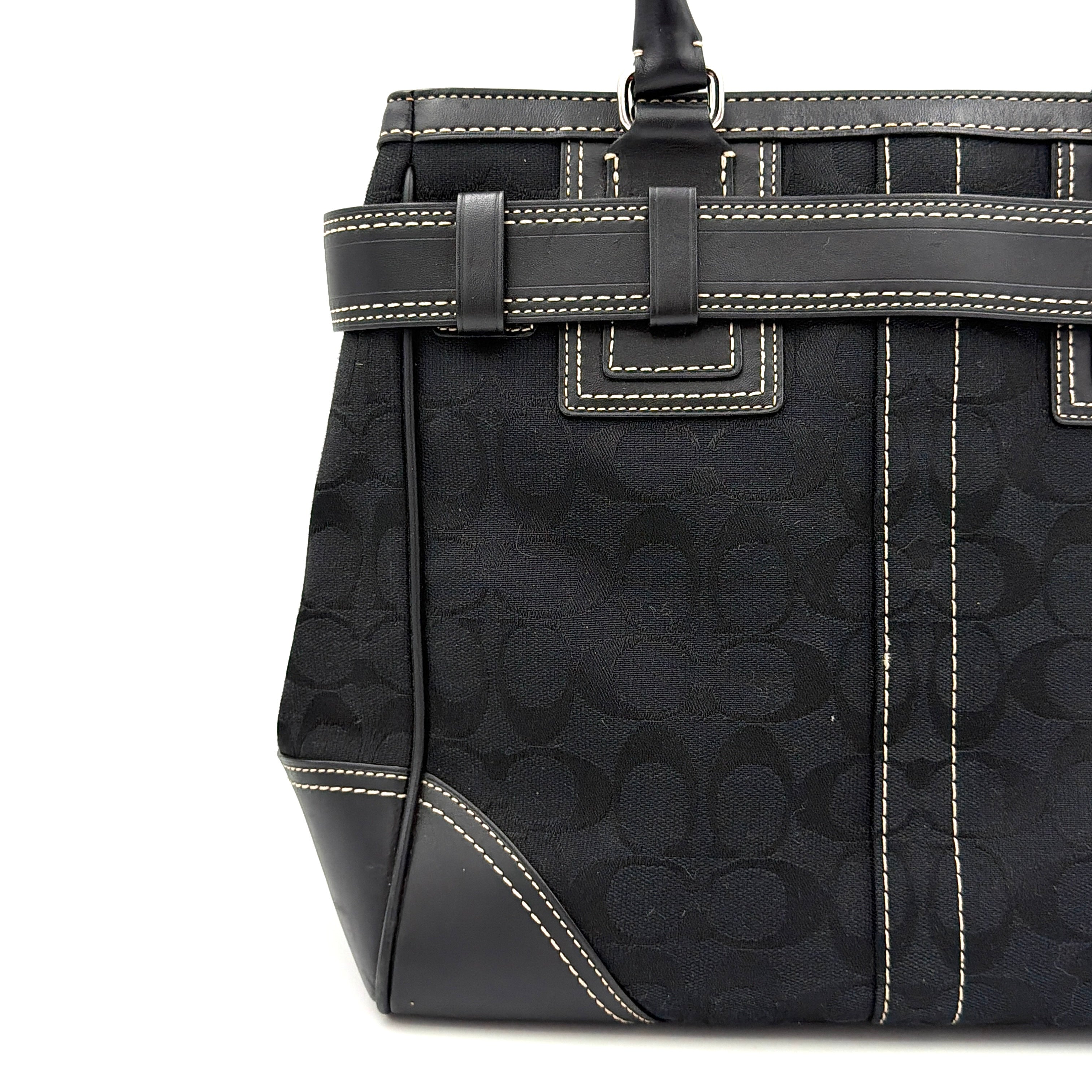 Coach Signature Hampton Carryall in black with monogram jacquard, belted leather trim, and silver-tone horsebit hardware.