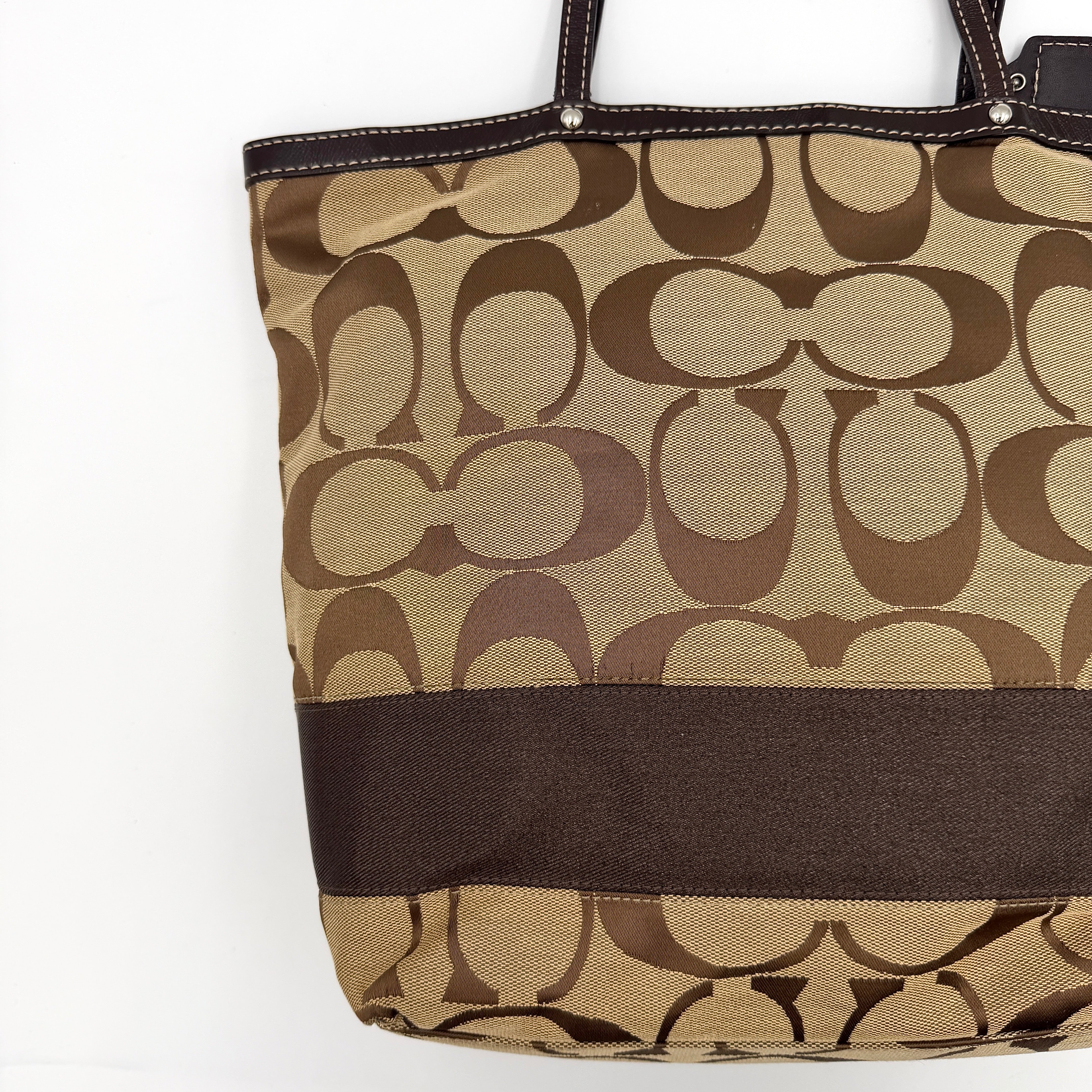 Coach Signature Stripe Tote Bag in brown and beige monogram canvas with chocolate stripe and leather handles, photographed upright.
