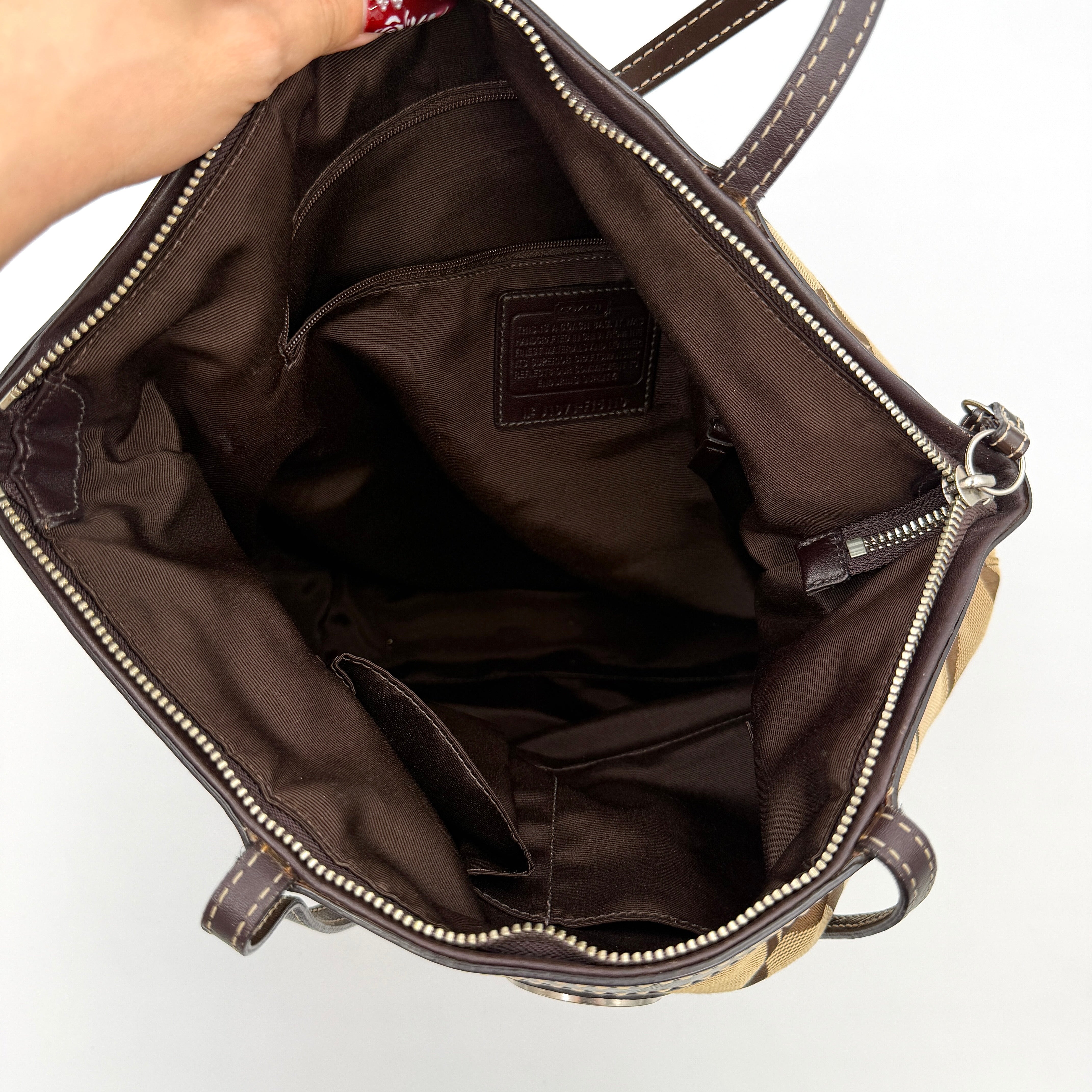 Coach Signature Stripe Tote Bag in brown and beige monogram canvas with chocolate stripe and leather handles, photographed upright.