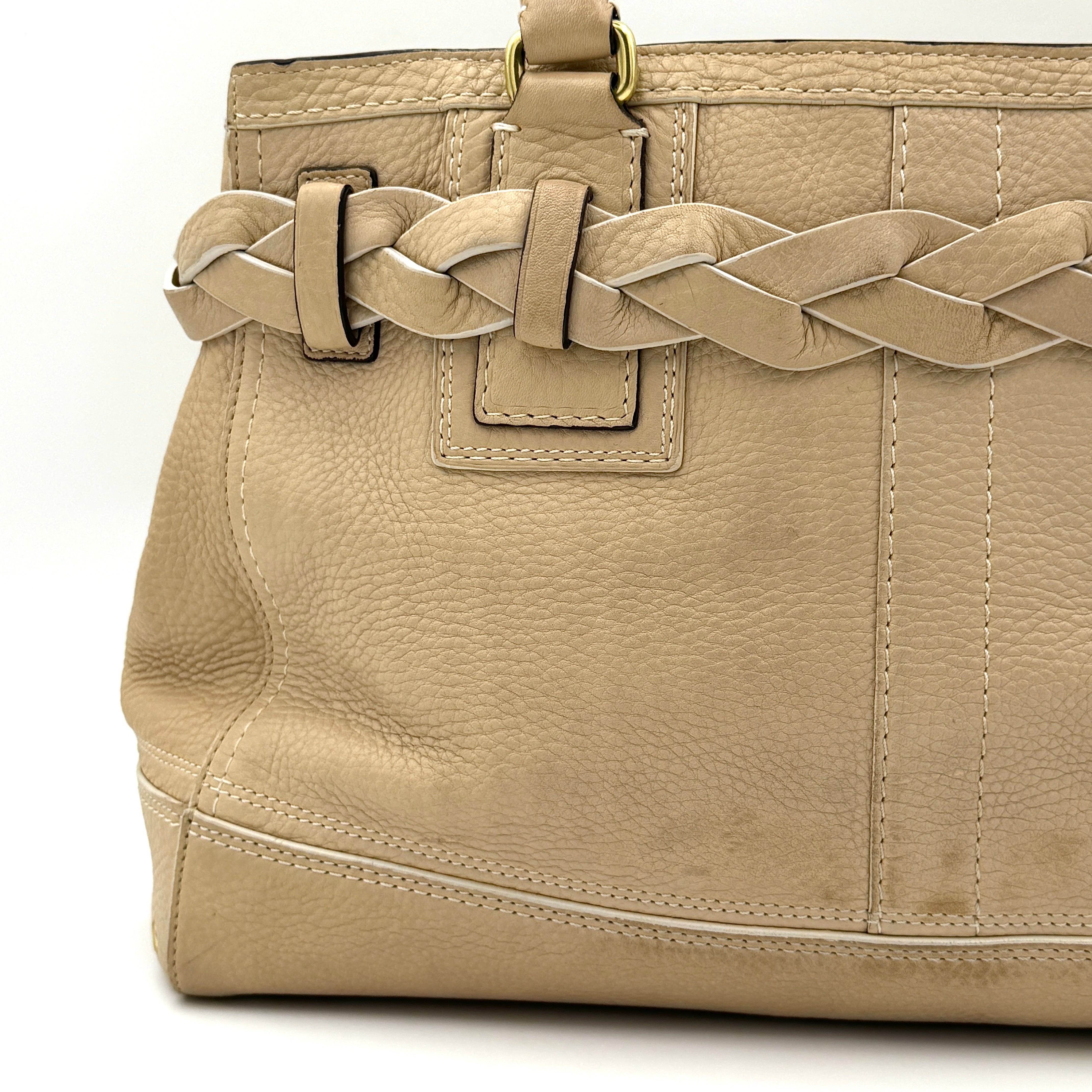Coach beige Hampton Carryall Shoulder Bag with braided leather details, gold hardware, and tassel accent, displayed front-facing.