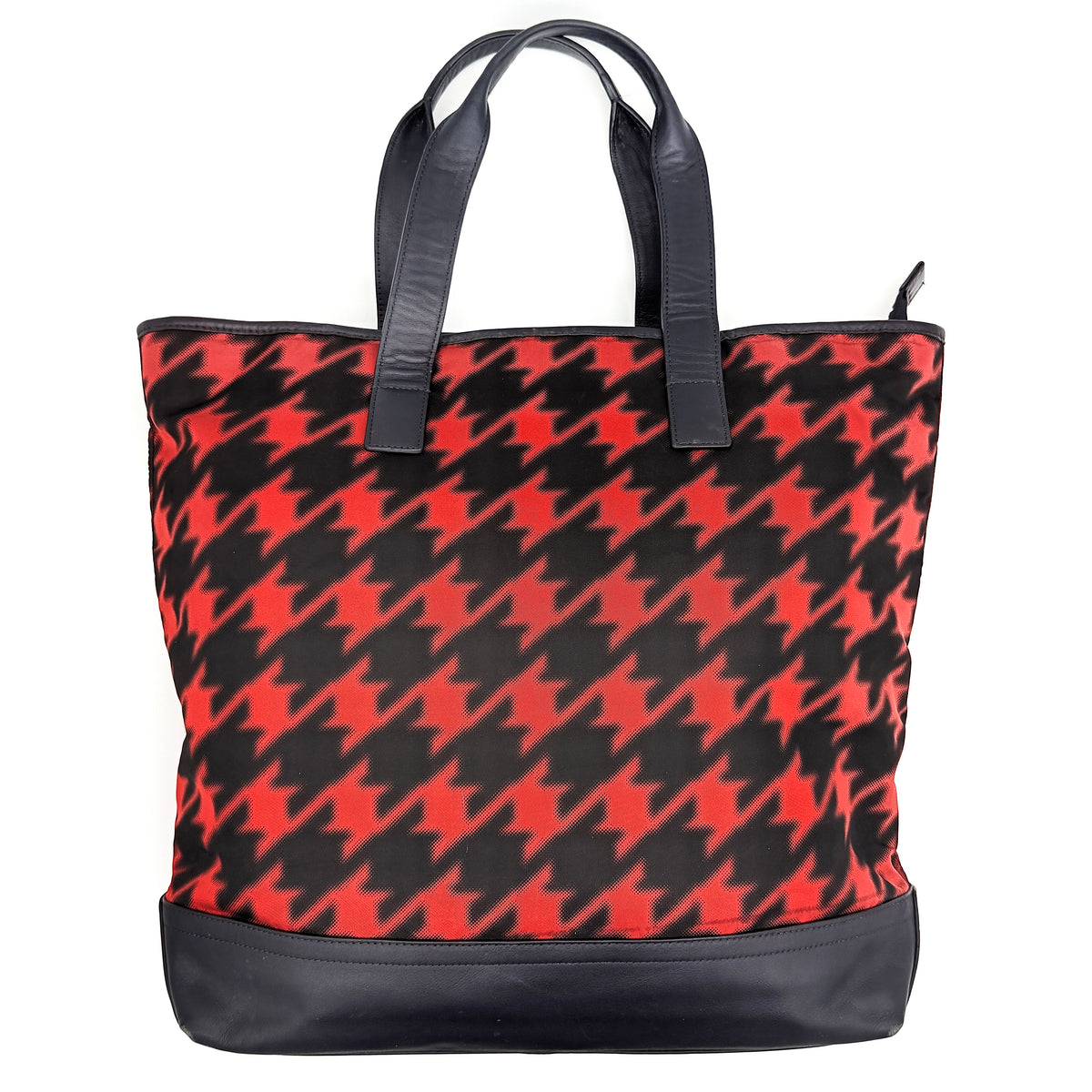 Coach Mercer Print Houndstooth Tote Bag in red and black with leather trim and handles, photographed upright against a white background.