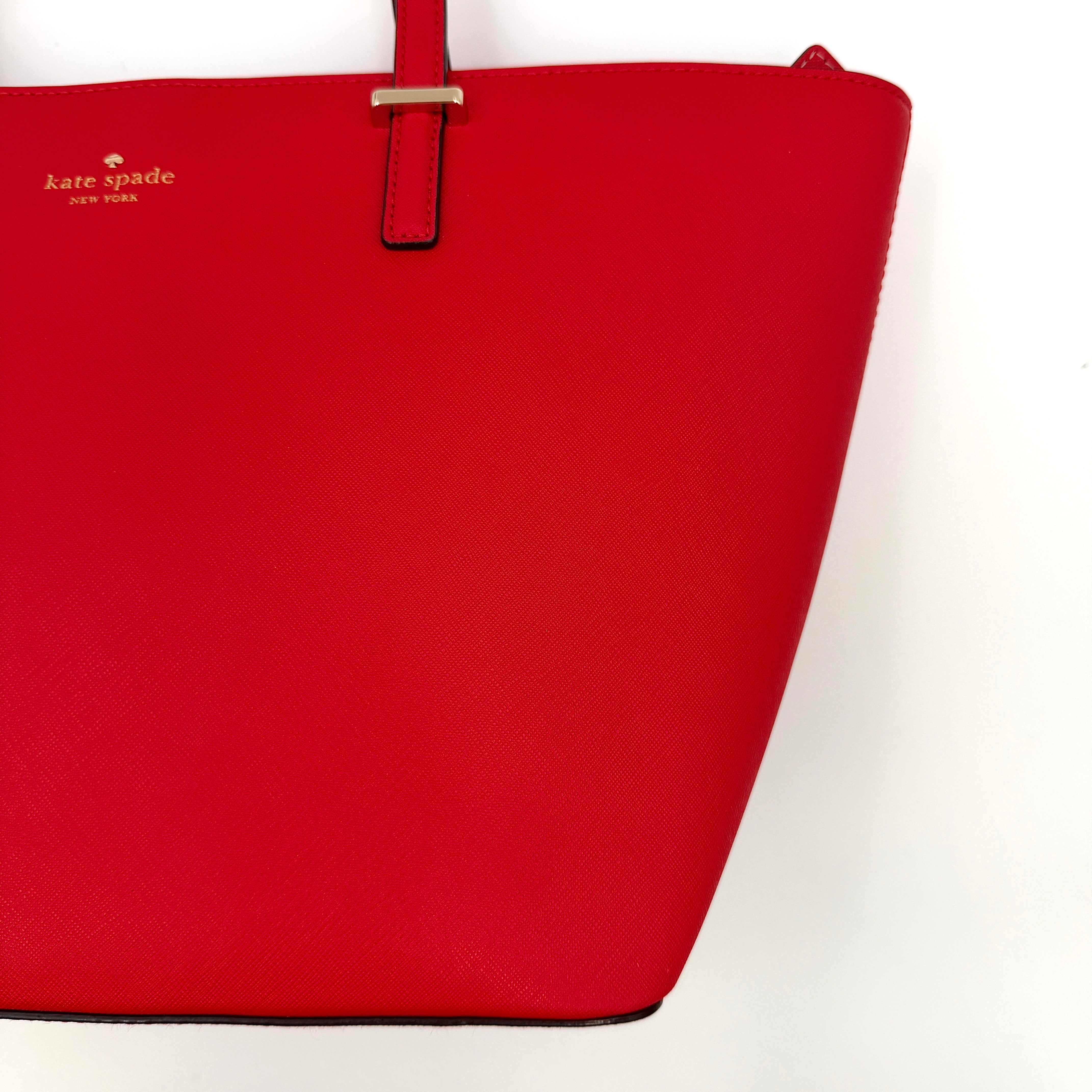 Kate Spade Cedar Street Harmony Tote bag in bold red saffiano leather, featuring dual top handles and gold-tone details.