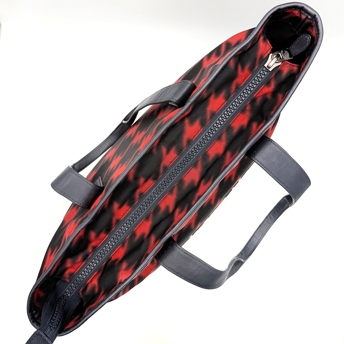 Coach Mercer Print Houndstooth Tote Bag in red and black with leather trim and handles, photographed upright against a white background.