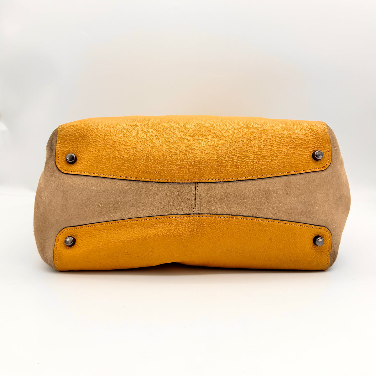 Coach Hadley Colorblock Hobo bag in yellow and brown leather with double top handles and suede side panels, shown against a white background.