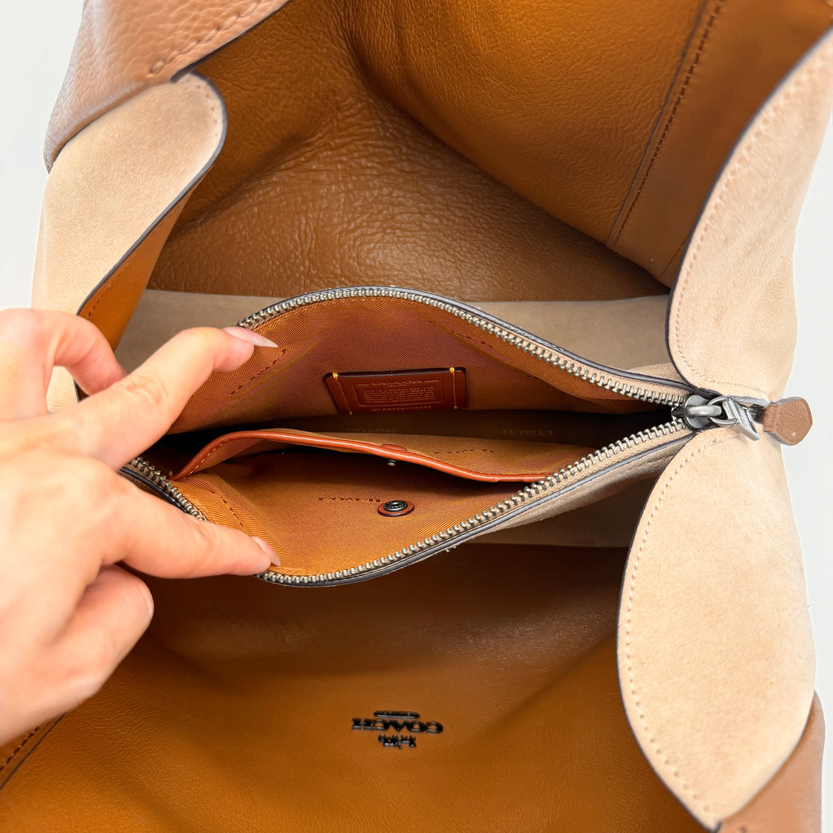 Coach Hadley Colorblock Hobo bag in yellow and brown leather with double top handles and suede side panels, shown against a white background.