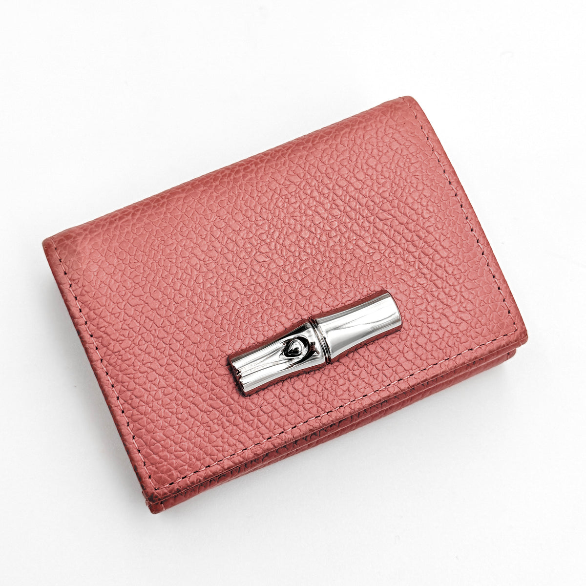 Longchamp Le Roseau compact wallet in pink grained leather with signature silver bamboo clasp.