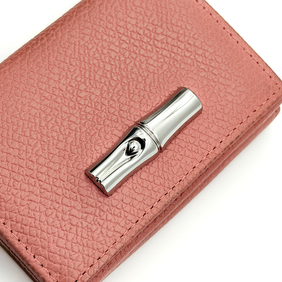 Longchamp Le Roseau compact wallet in pink grained leather with signature silver bamboo clasp.