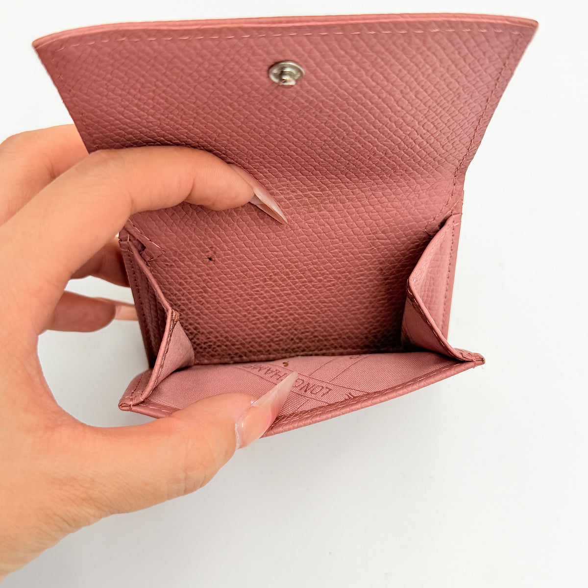 Longchamp Le Roseau compact wallet in pink grained leather with signature silver bamboo clasp.