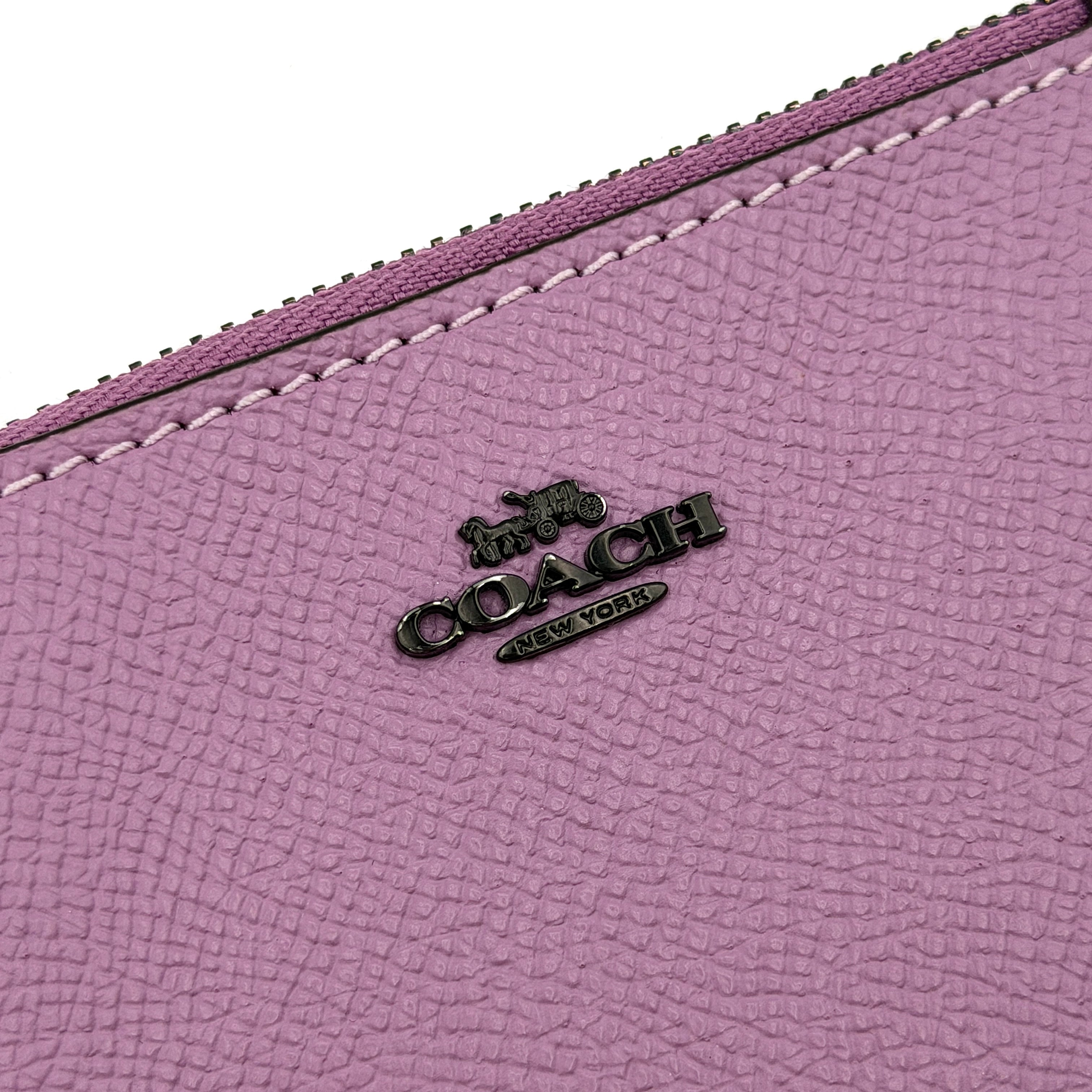 Coach Mini Skinny ID Case in purple pebbled leather with black hardware, featuring a zip closure and key ring.