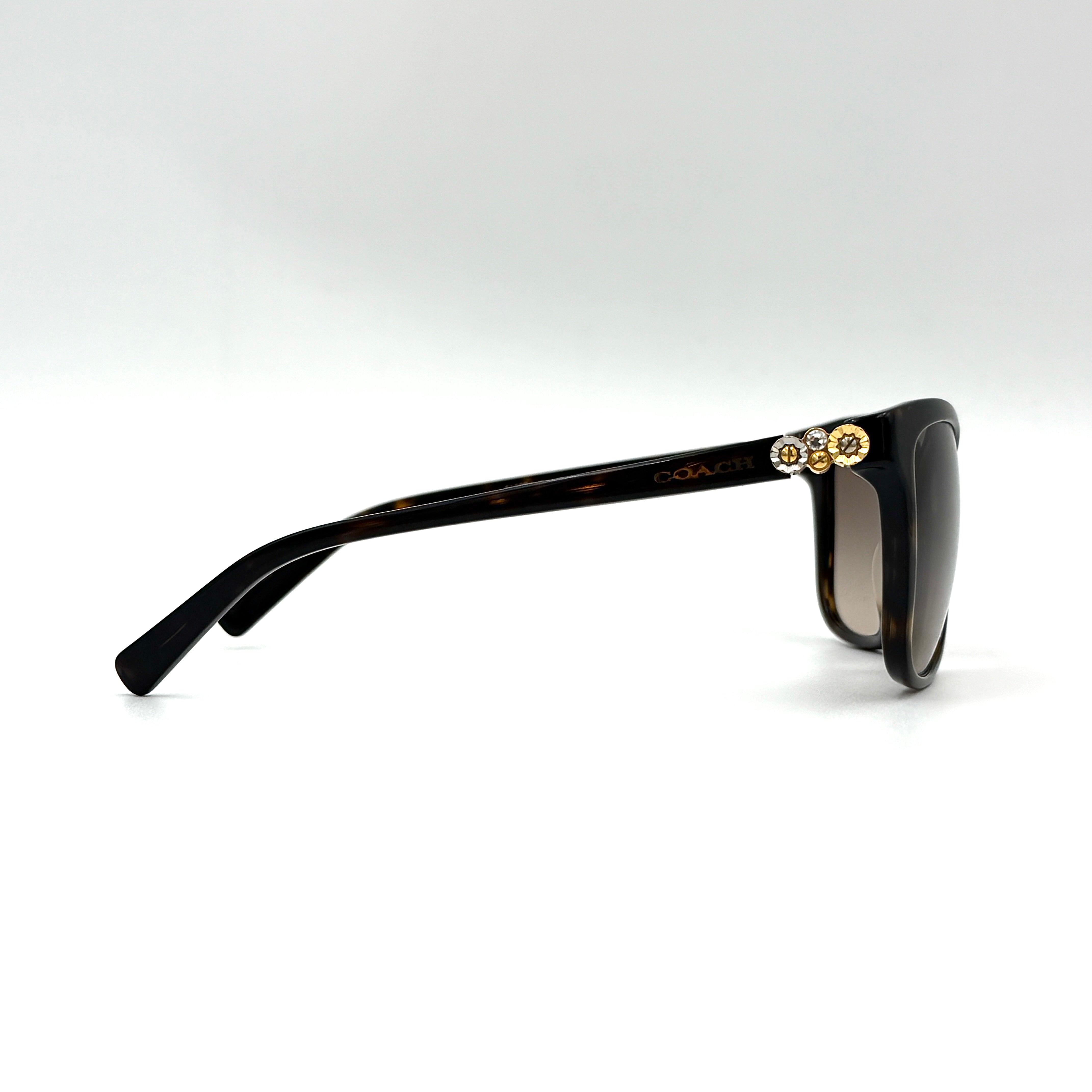 Coach HC8187BF sunglasses in dark tortoise acetate with gold floral and crystal temple detailing, shown in a three-quarter profile.