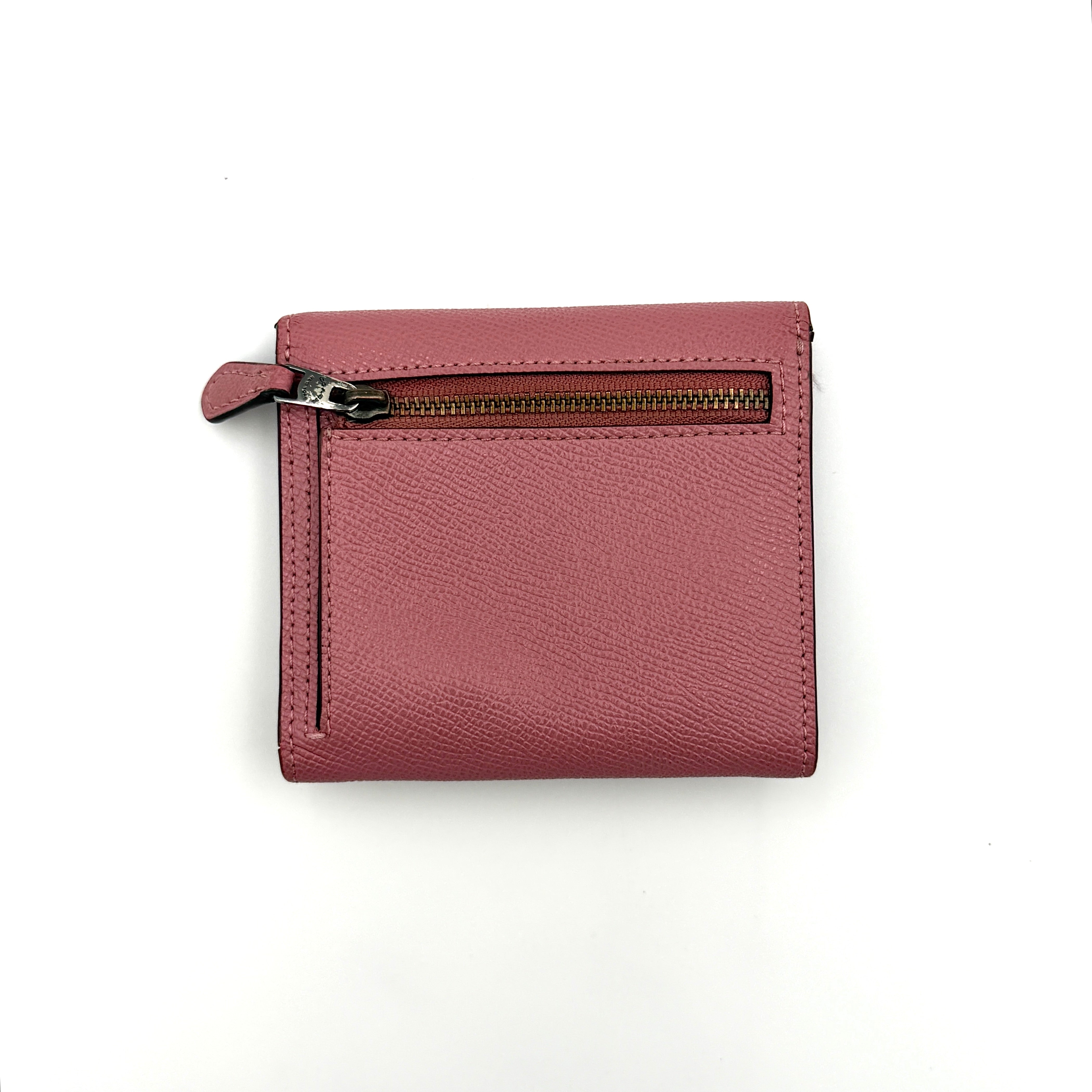 Coach Envelope Small Wallet in dusky pink grained leather with silver hardware and an angular flap closure.