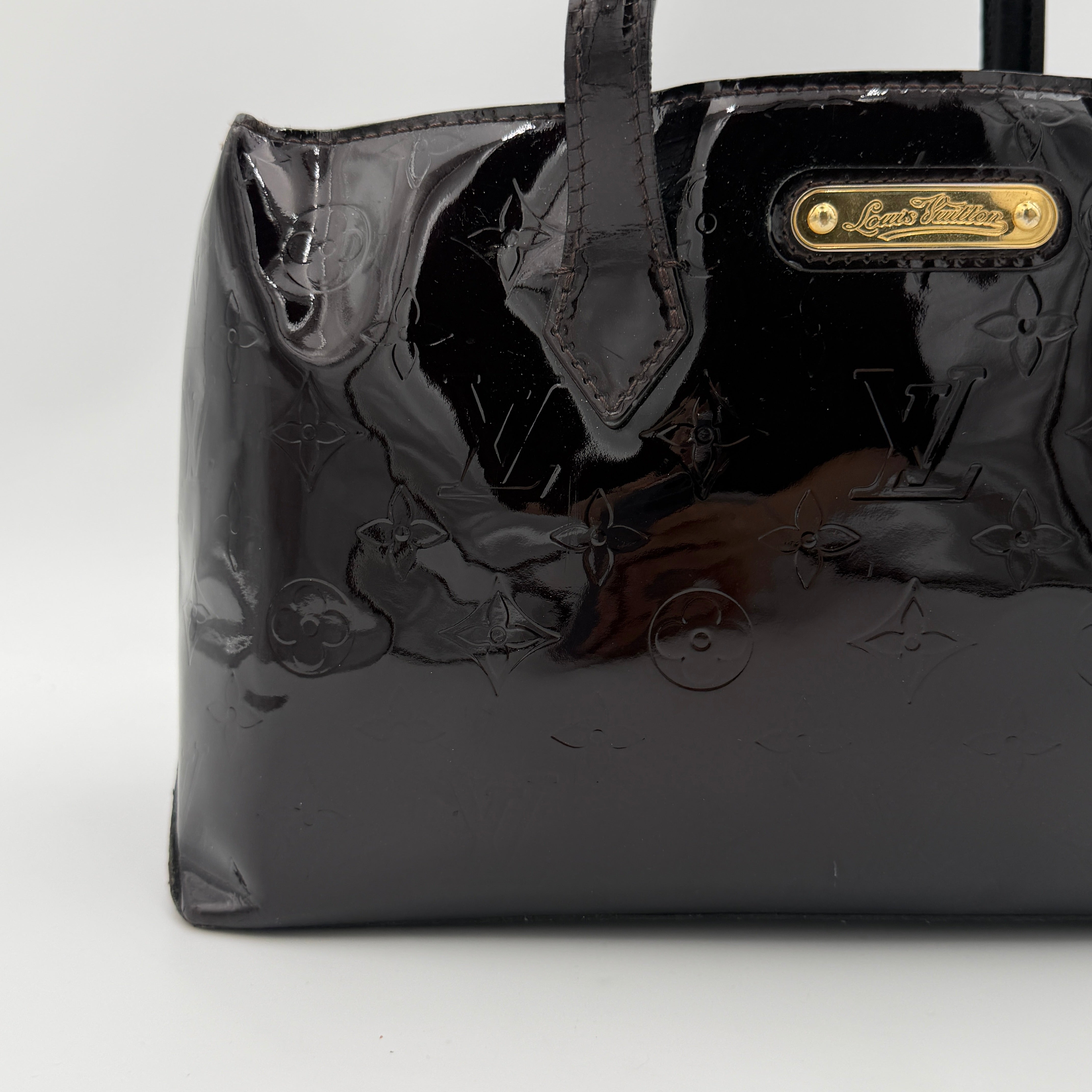 Louis Vuitton Monogram Rosewood Avenue Vernis Shoulder Bag in dark purple Vernis leather with gold-tone hardware, shown upright against a neutral backdrop.