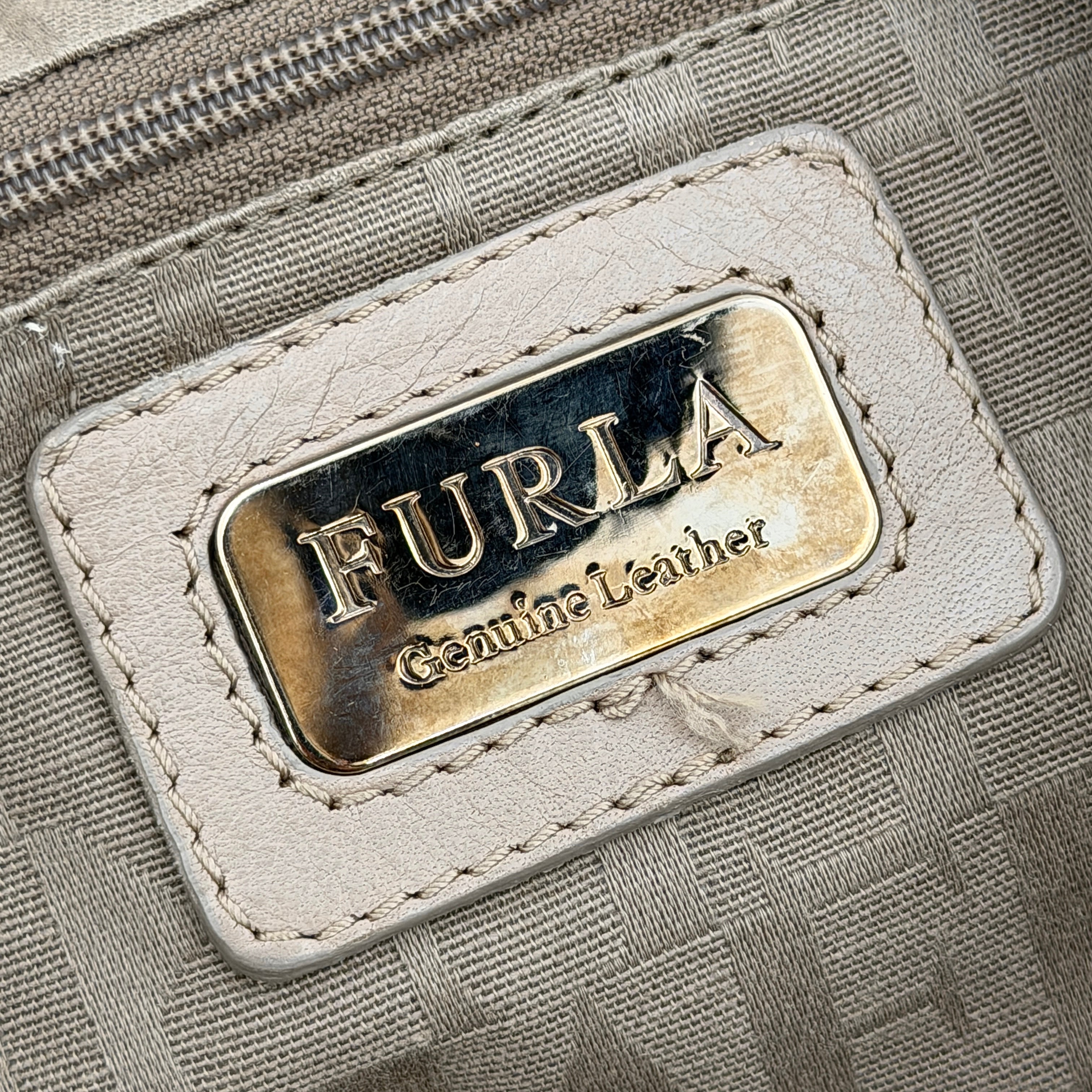 Furla light brown python-embossed hobo bag with perforated leather, silver hardware, and double handles.