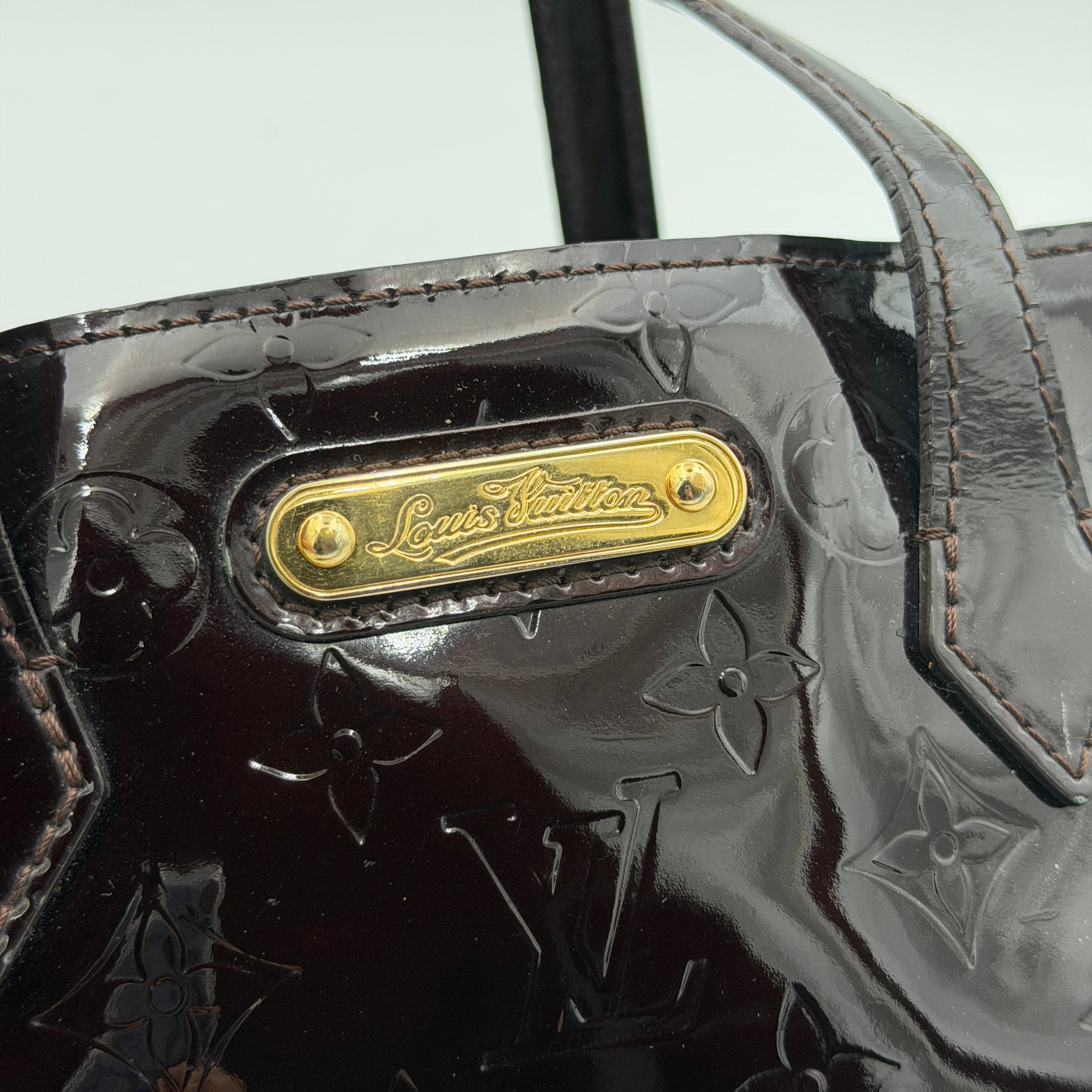 Louis Vuitton Monogram Rosewood Avenue Vernis Shoulder Bag in dark purple Vernis leather with gold-tone hardware, shown upright against a neutral backdrop.