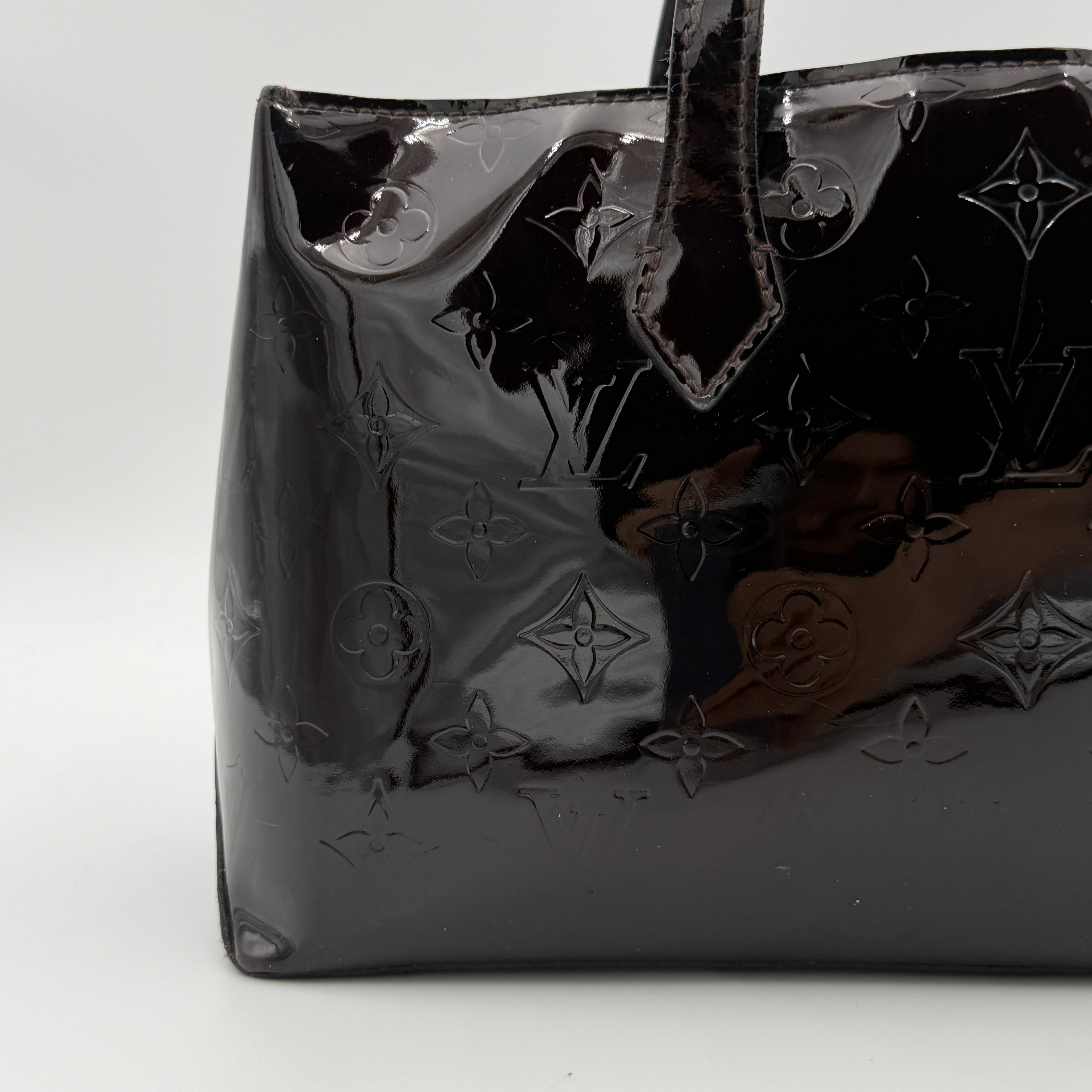Louis Vuitton Monogram Rosewood Avenue Vernis Shoulder Bag in dark purple Vernis leather with gold-tone hardware, shown upright against a neutral backdrop.