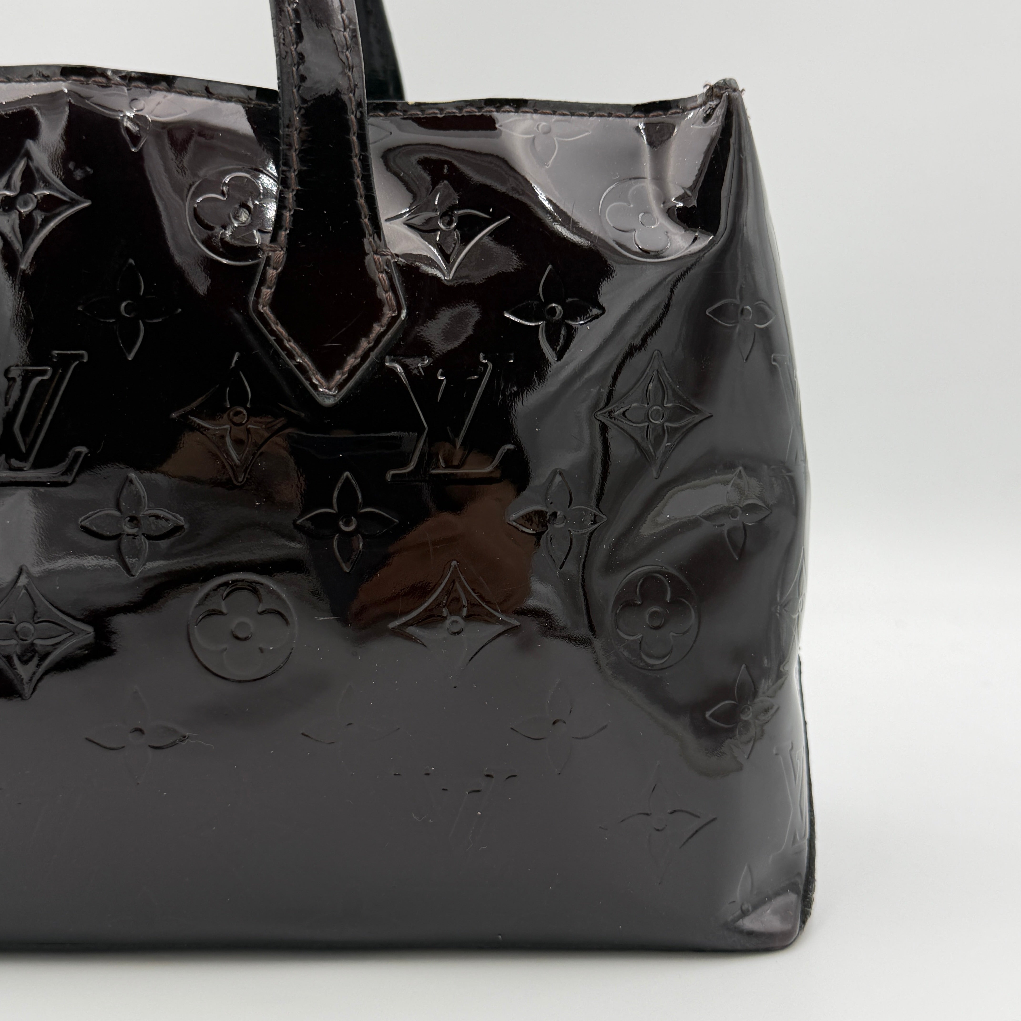 Louis Vuitton Monogram Rosewood Avenue Vernis Shoulder Bag in dark purple Vernis leather with gold-tone hardware, shown upright against a neutral backdrop.