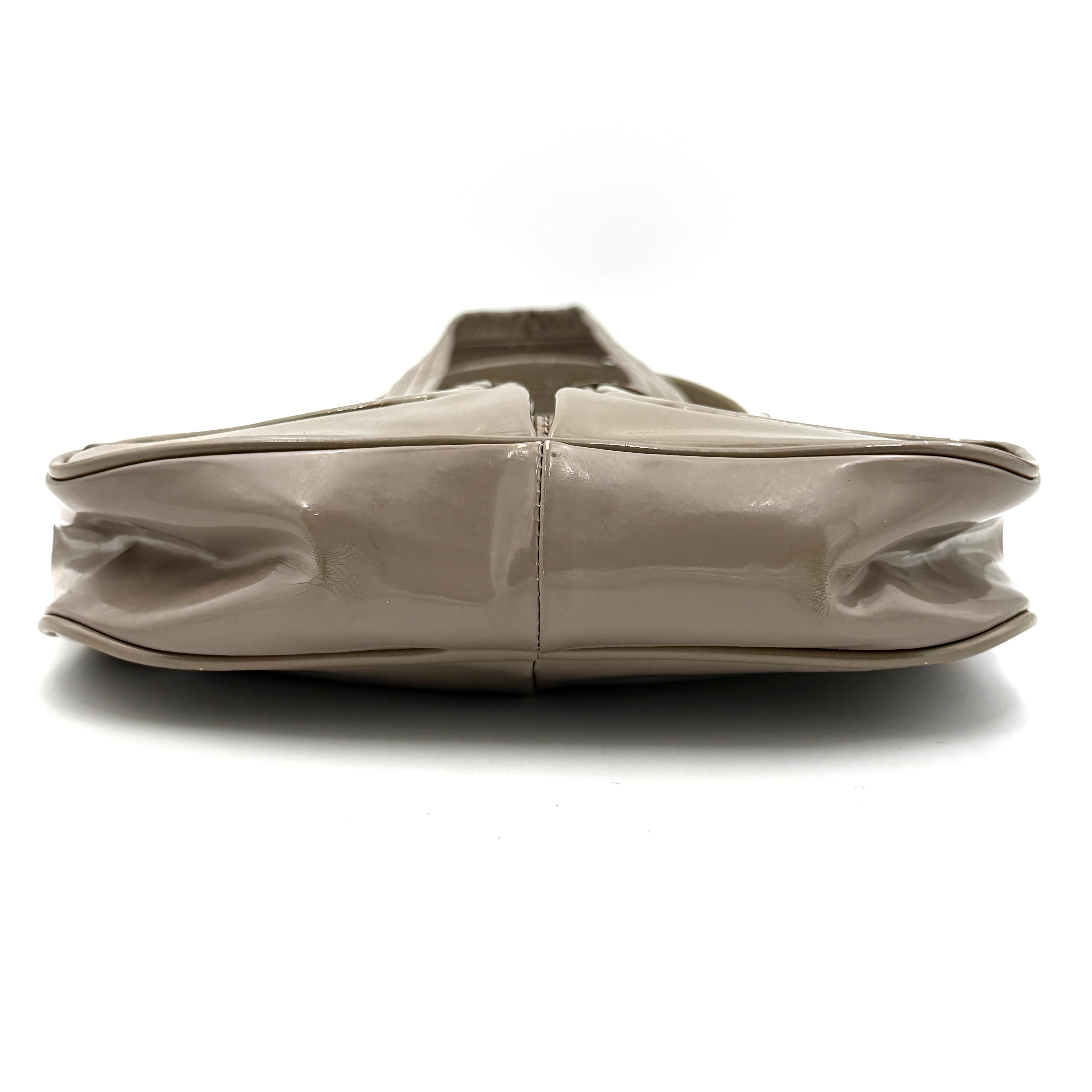 Marc Jacobs grey patent leather shoulder bag with double front turnlock pockets and structured dual handles.