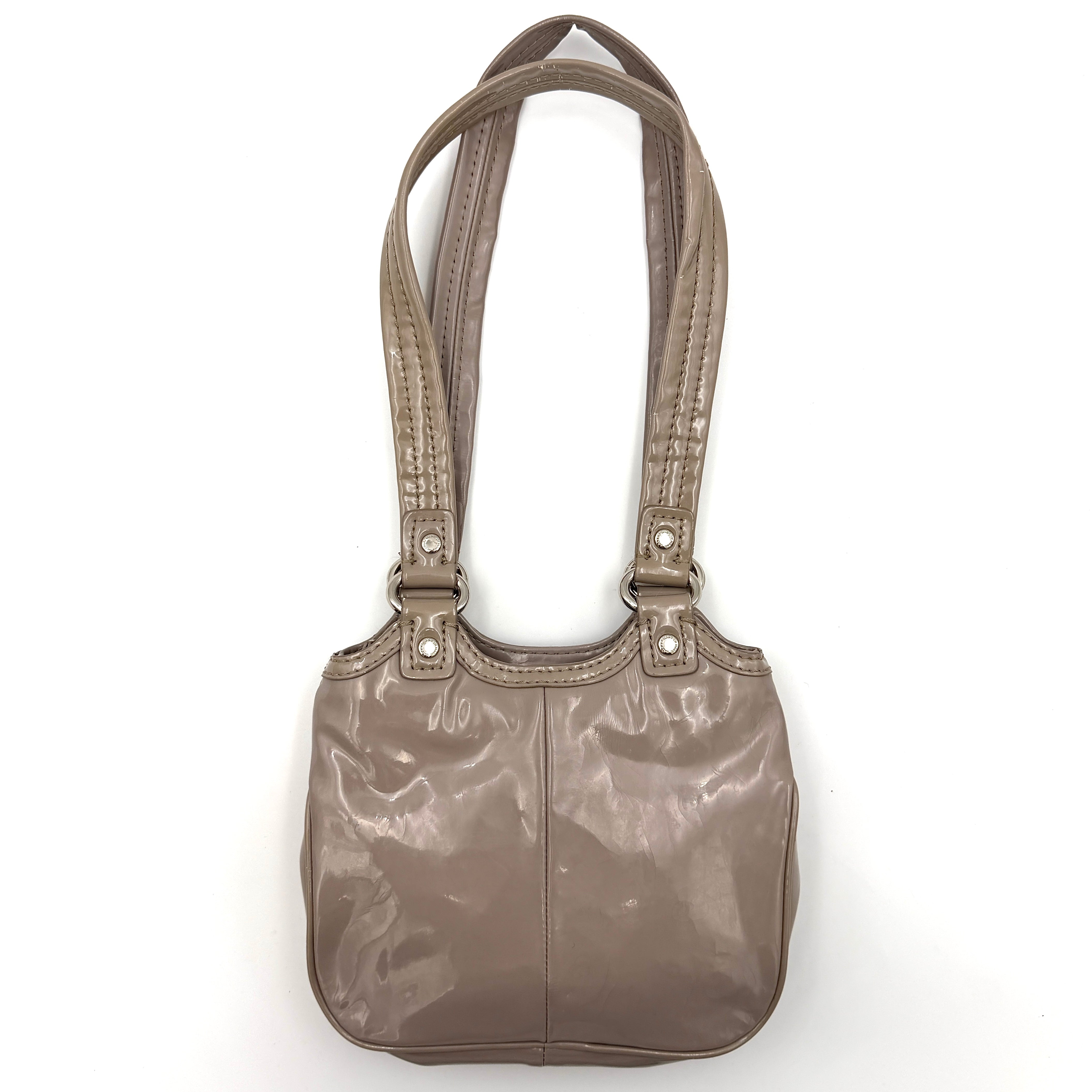 Marc Jacobs grey patent leather shoulder bag with double front turnlock pockets and structured dual handles.