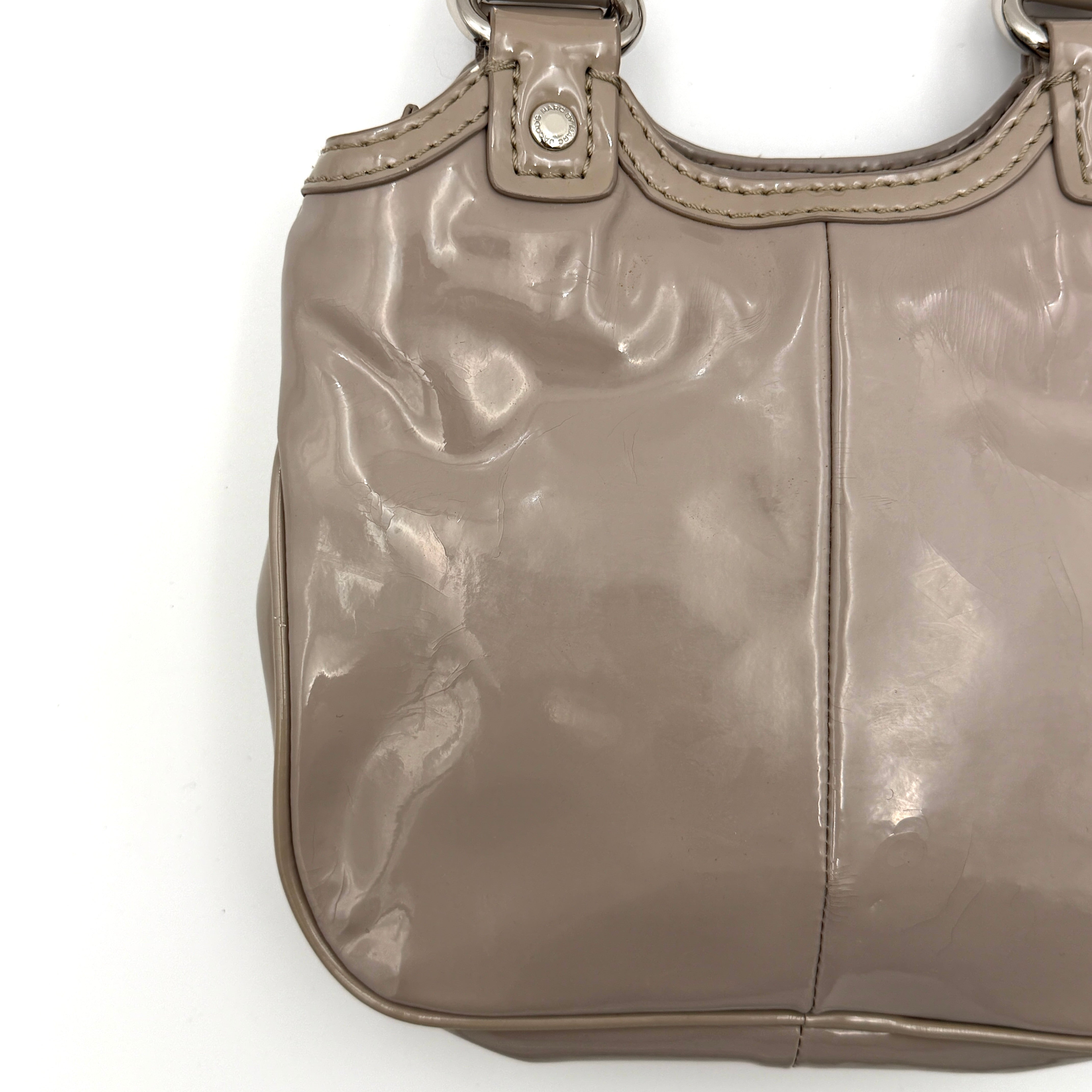 Marc Jacobs grey patent leather shoulder bag with double front turnlock pockets and structured dual handles.