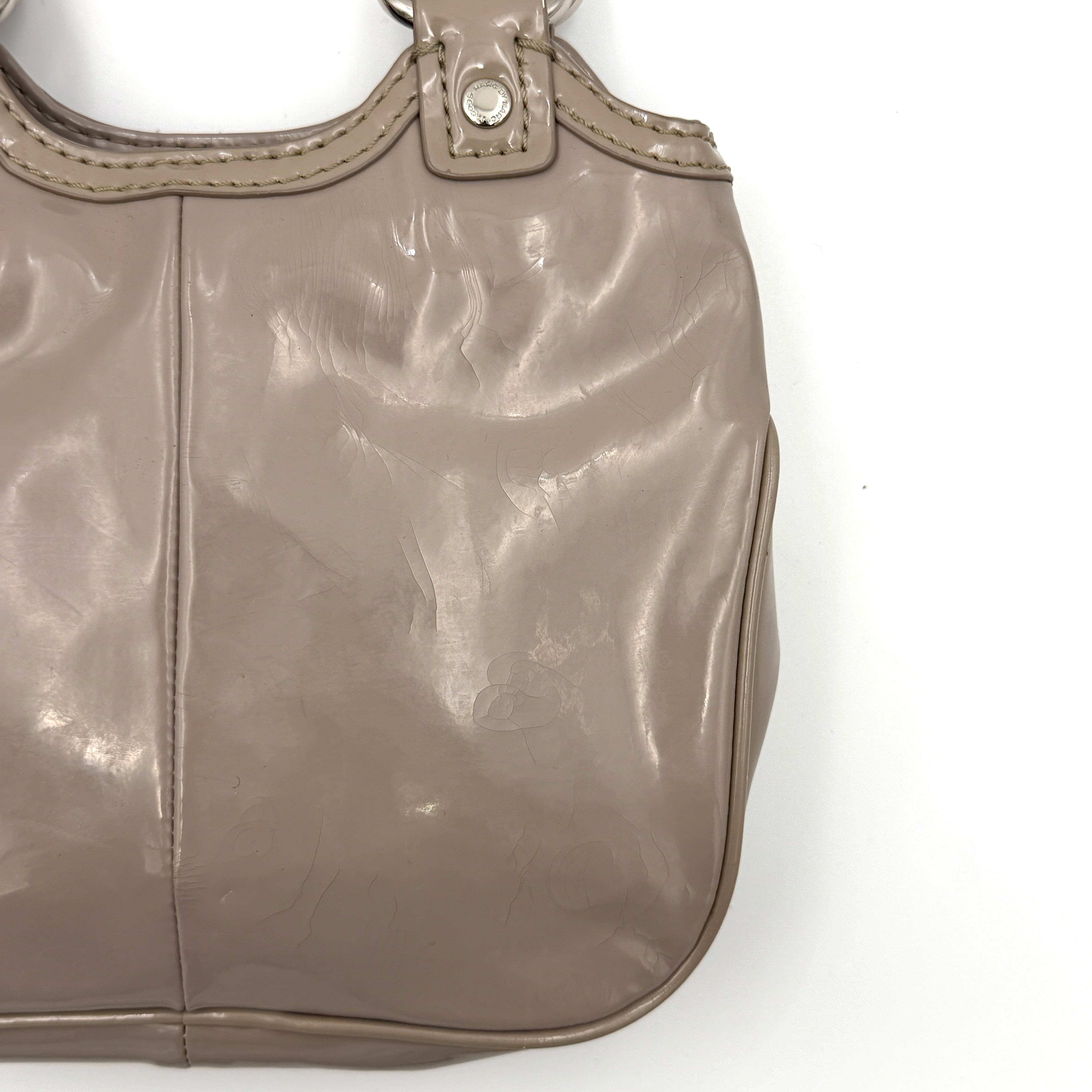 Marc Jacobs grey patent leather shoulder bag with double front turnlock pockets and structured dual handles.