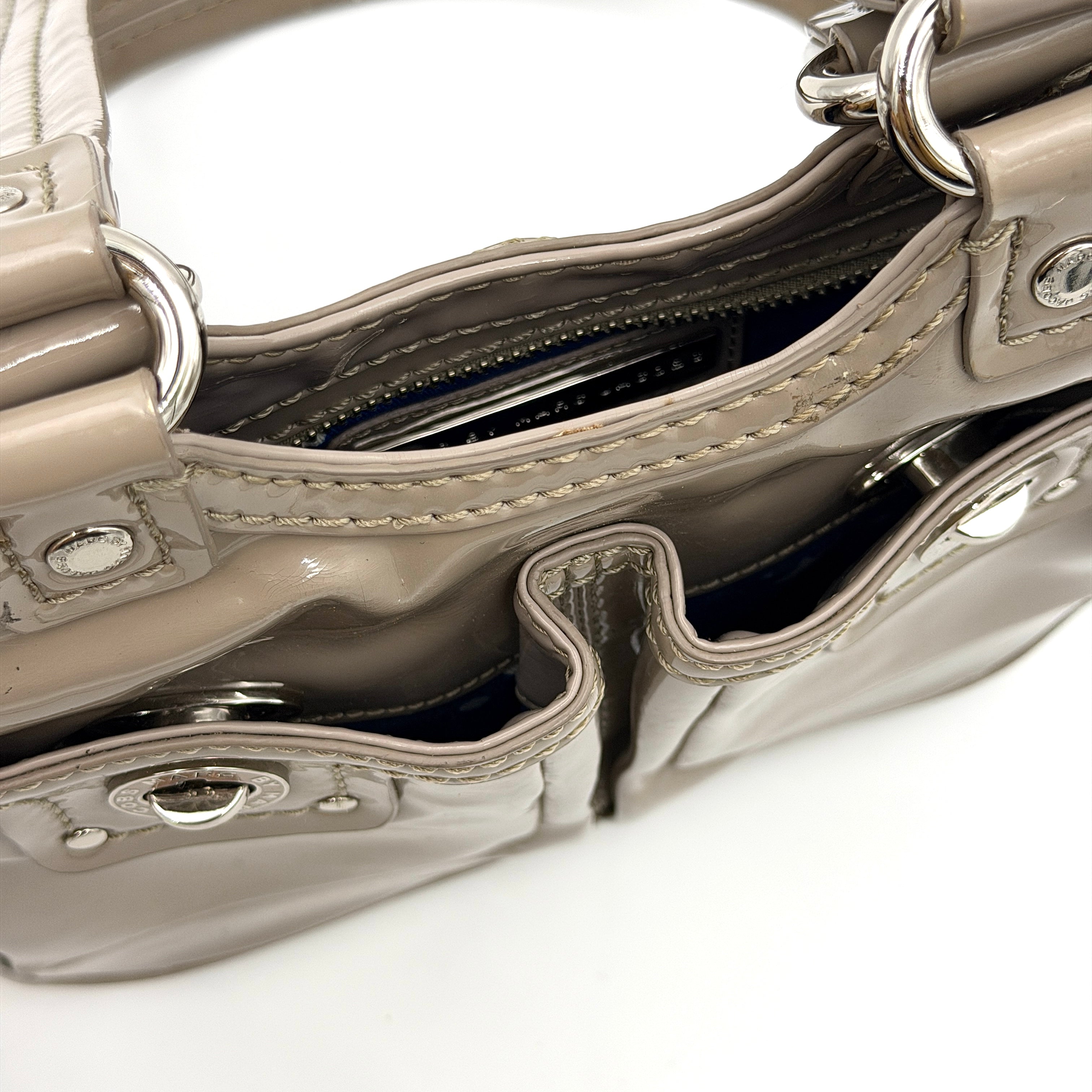 Marc Jacobs grey patent leather shoulder bag with double front turnlock pockets and structured dual handles.